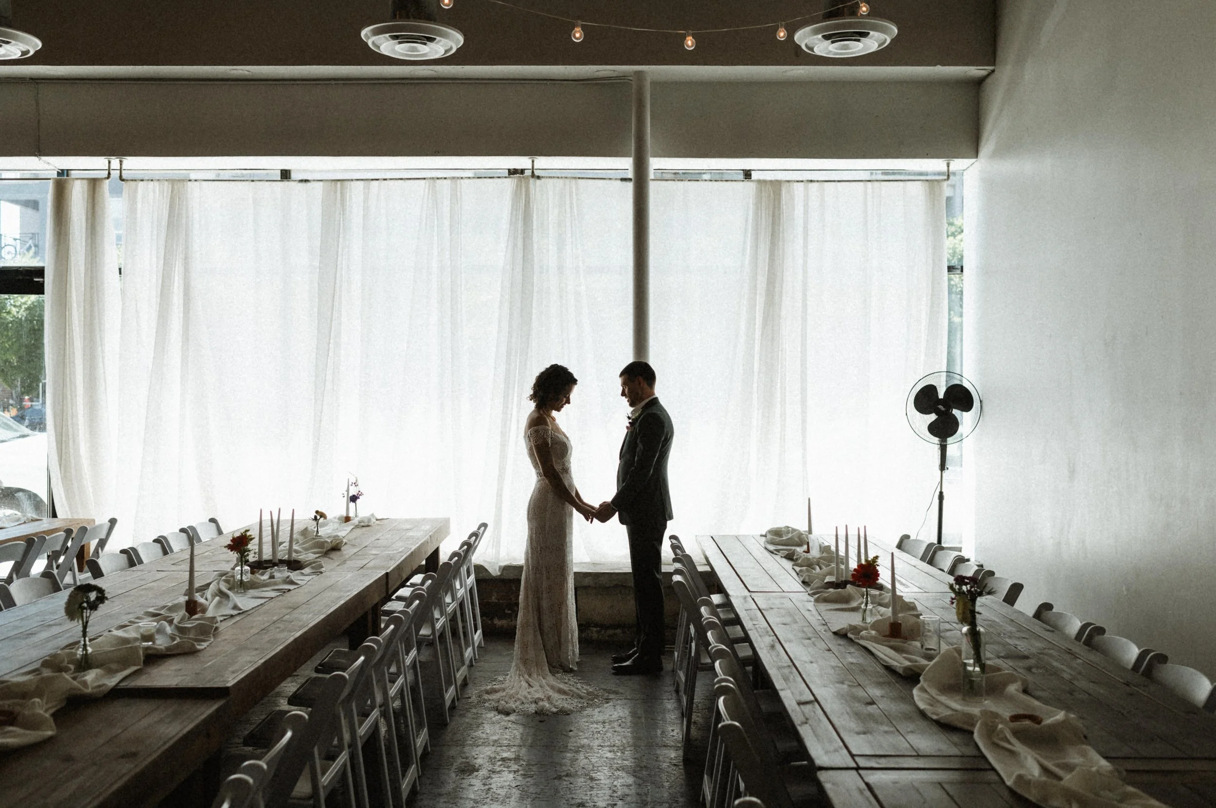Bride and groom portrait against industrial brick backdrop at Ember, downtown Salt Lake City
