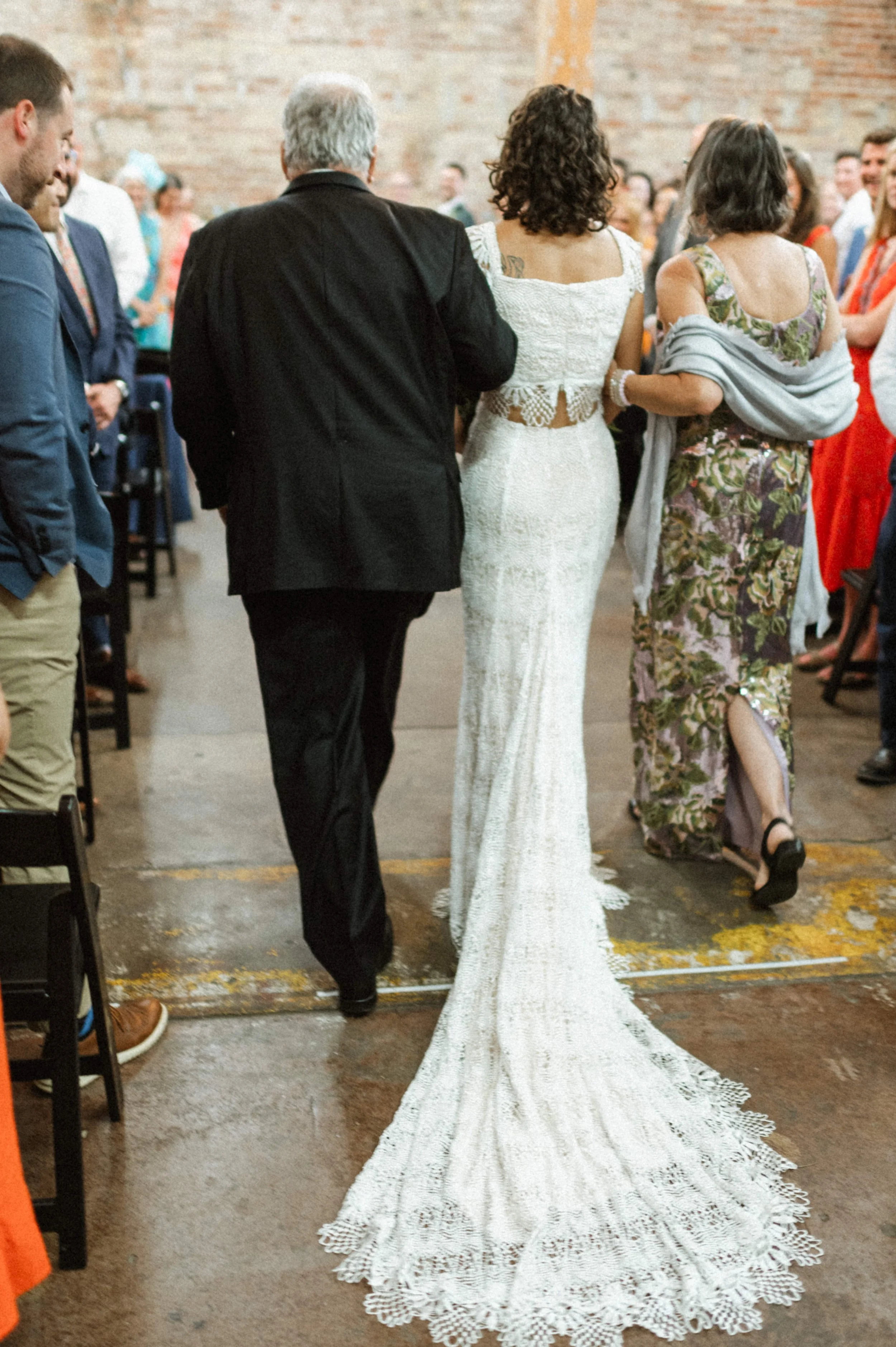 Bride walking down the aisle inside Ember's art deco-inspired ceremony space