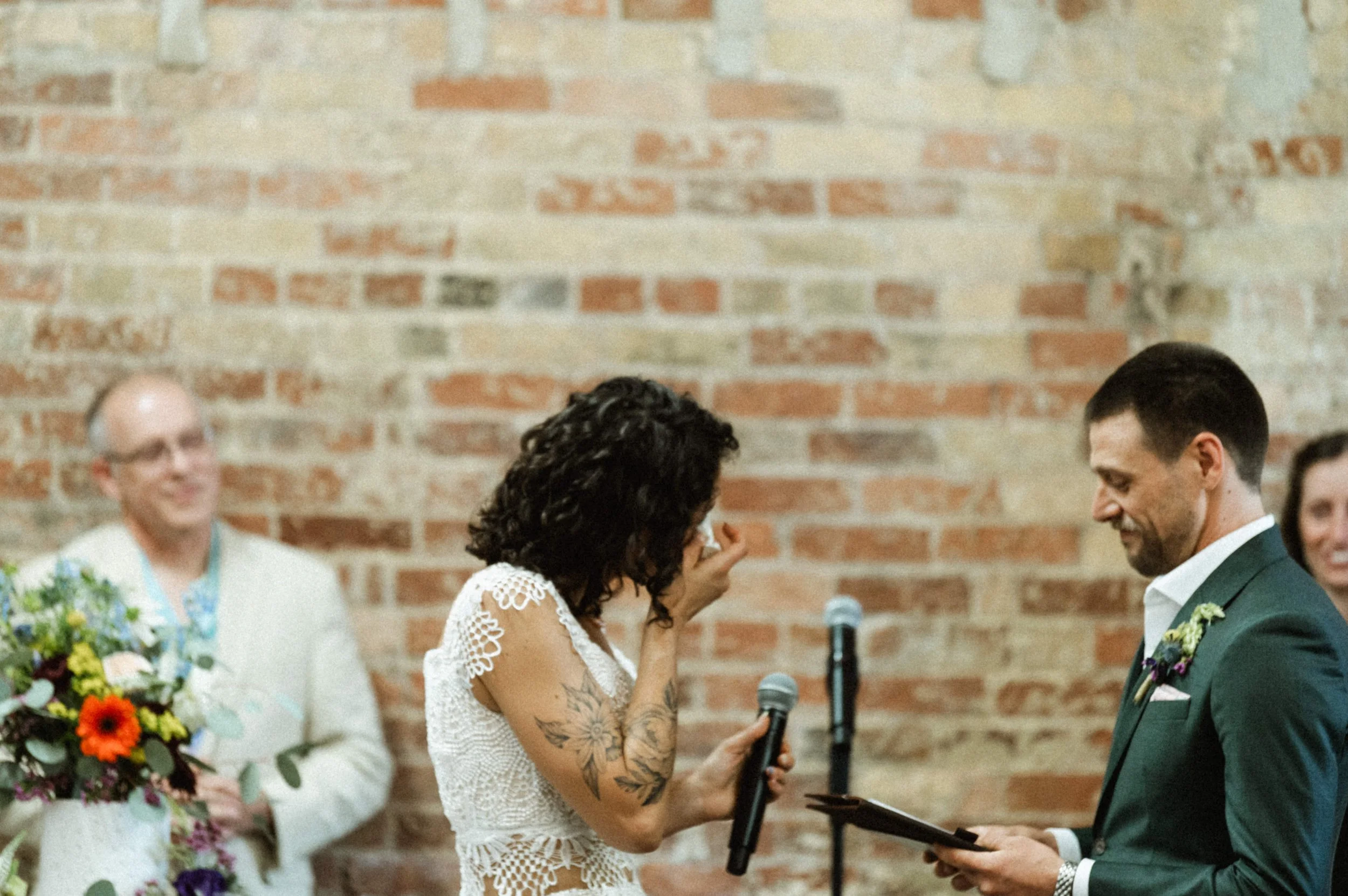 Eclectic modern wedding ceremony setup with exposed brick at Ember Studios