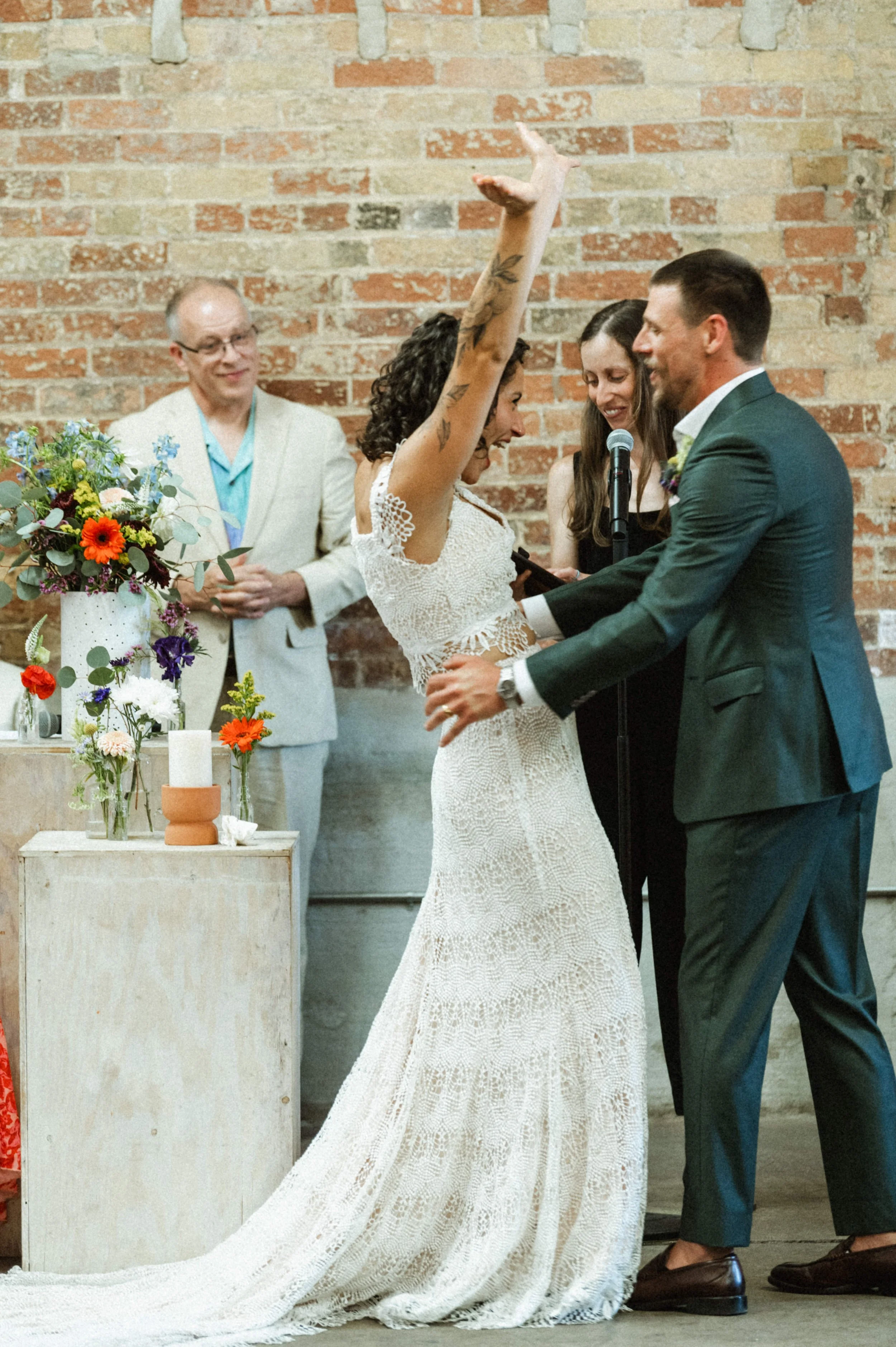Eclectic modern wedding ceremony setup with exposed brick at Ember Studios