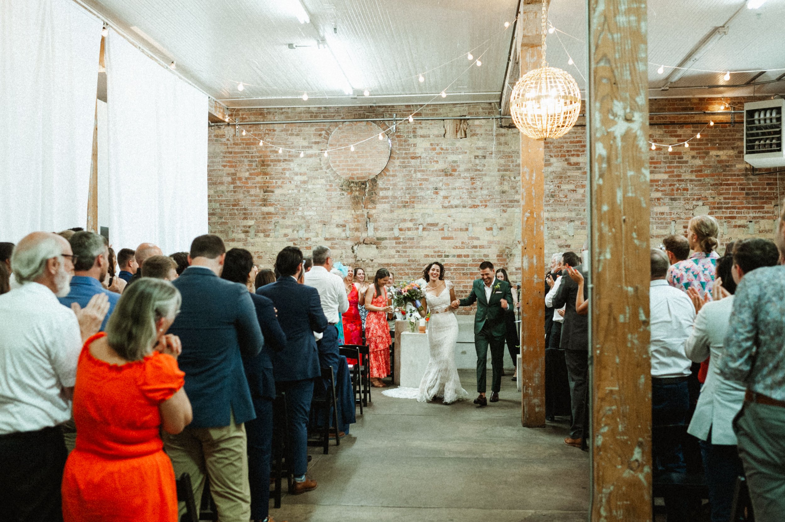 Wedding ceremony beneath vaulted industrial ceilings at Ember, Salt Lake City