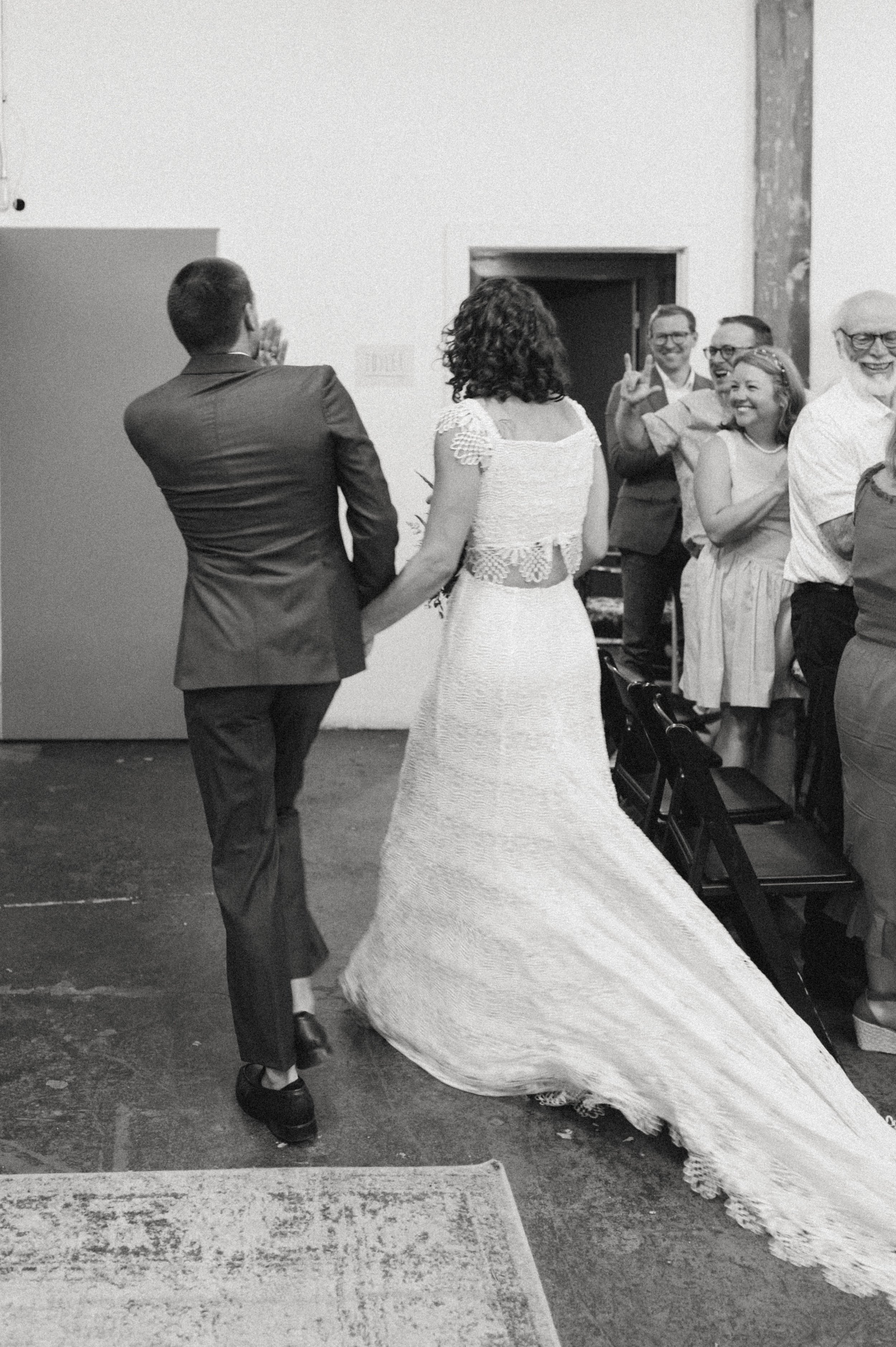 Wedding ceremony beneath vaulted industrial ceilings at Ember, Salt Lake City