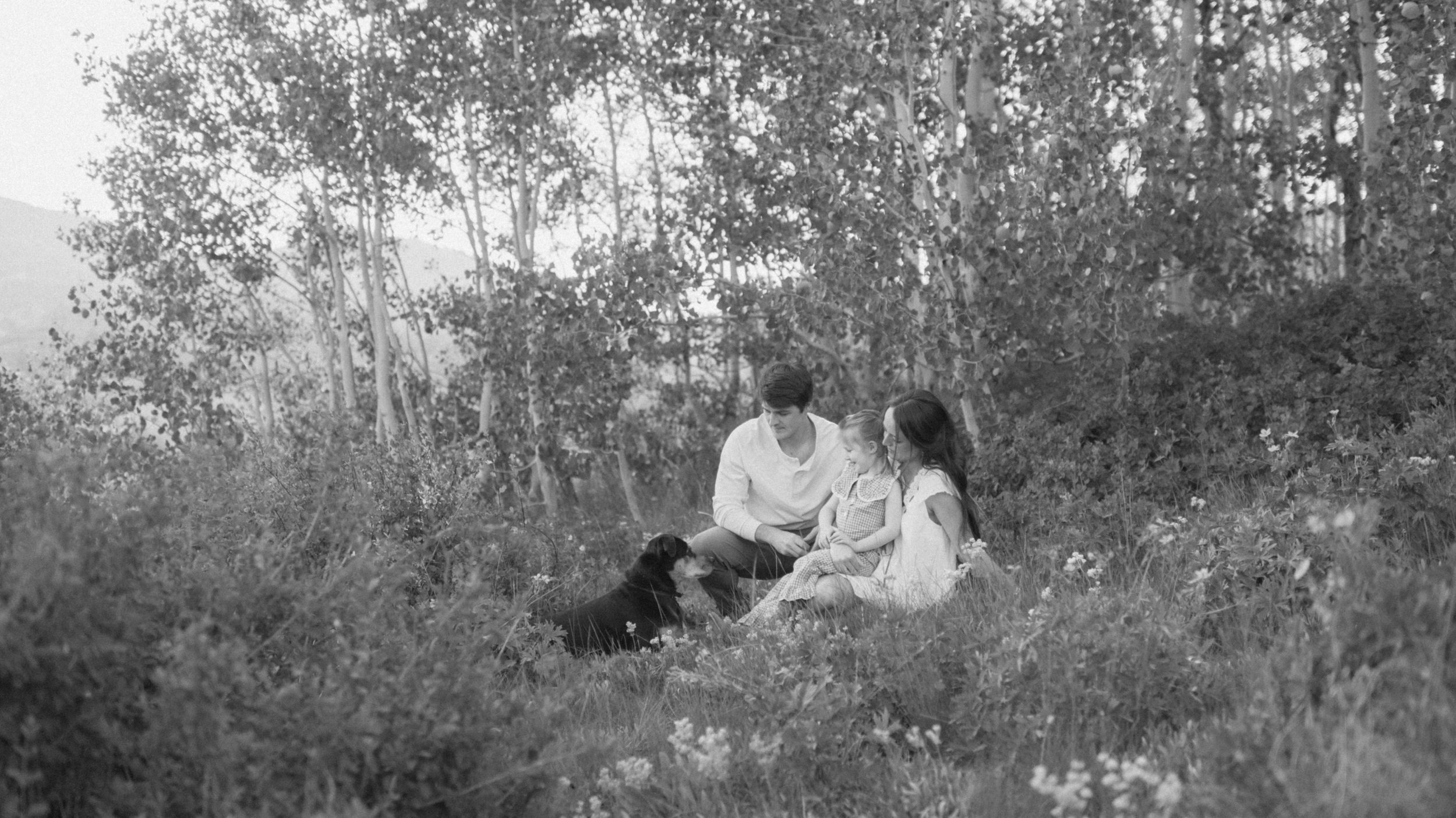 cinematic frame family of three walking through mountains