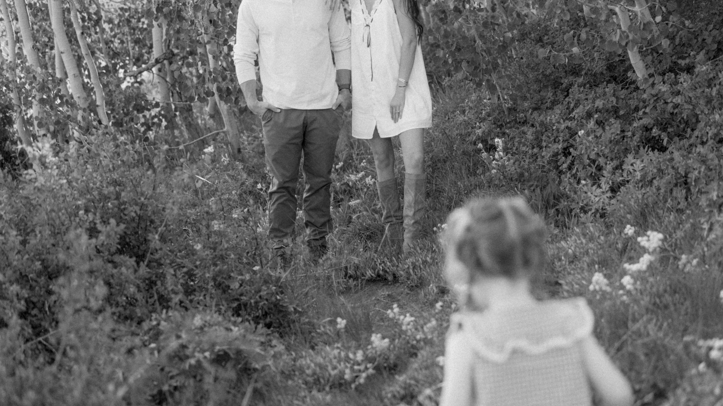 cinematic frame family of three walking through mountains