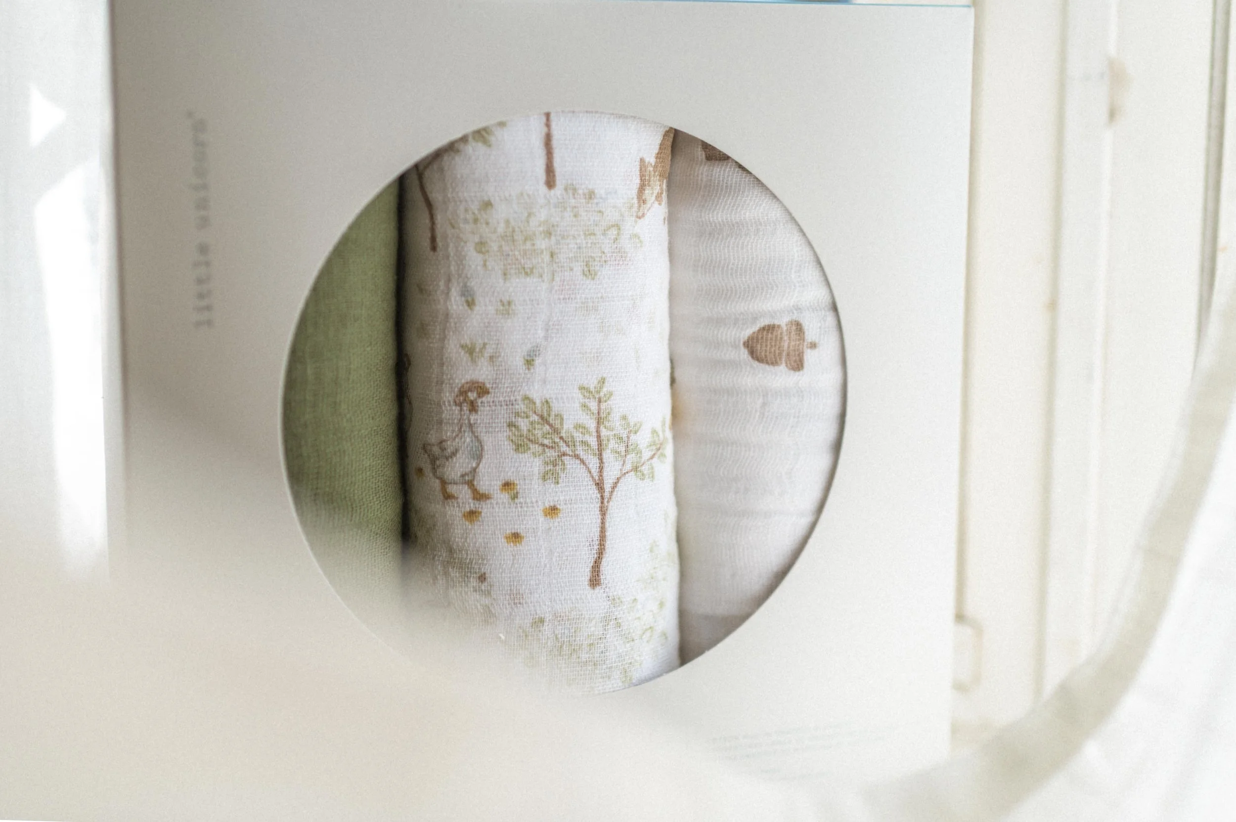 photo of organic cotton muslin blankets in packaging with circle opening