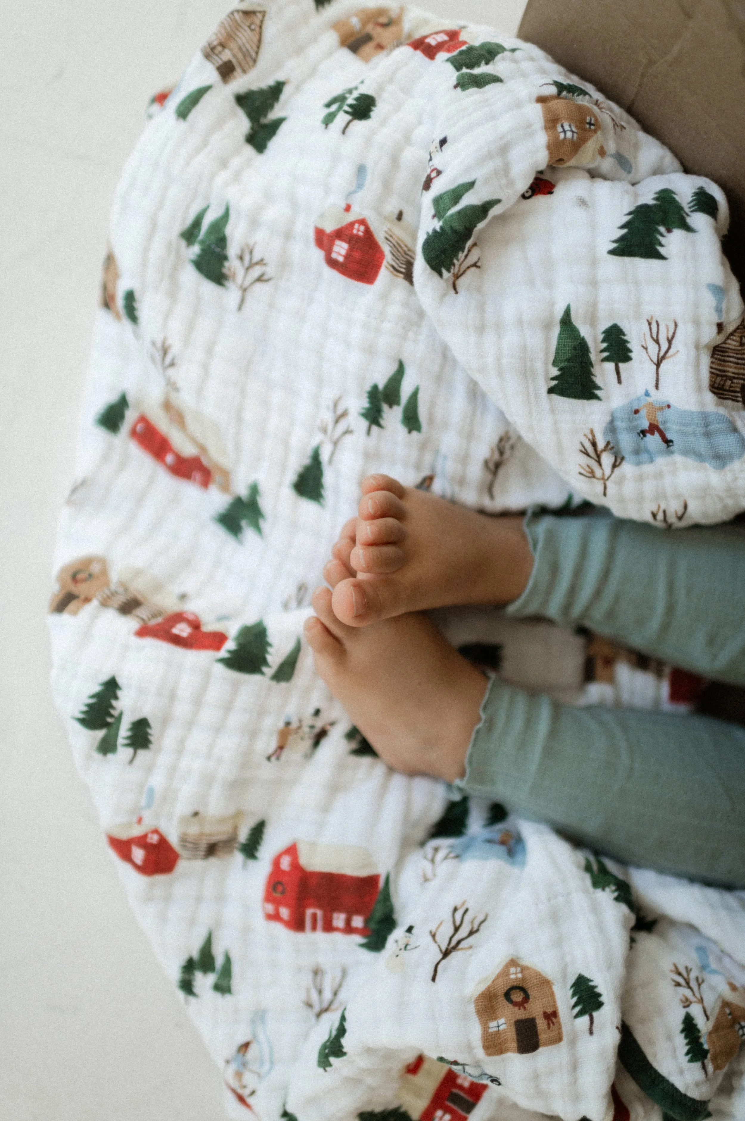 Detail shot of hand-painted holiday print on organic cotton muslin fabric