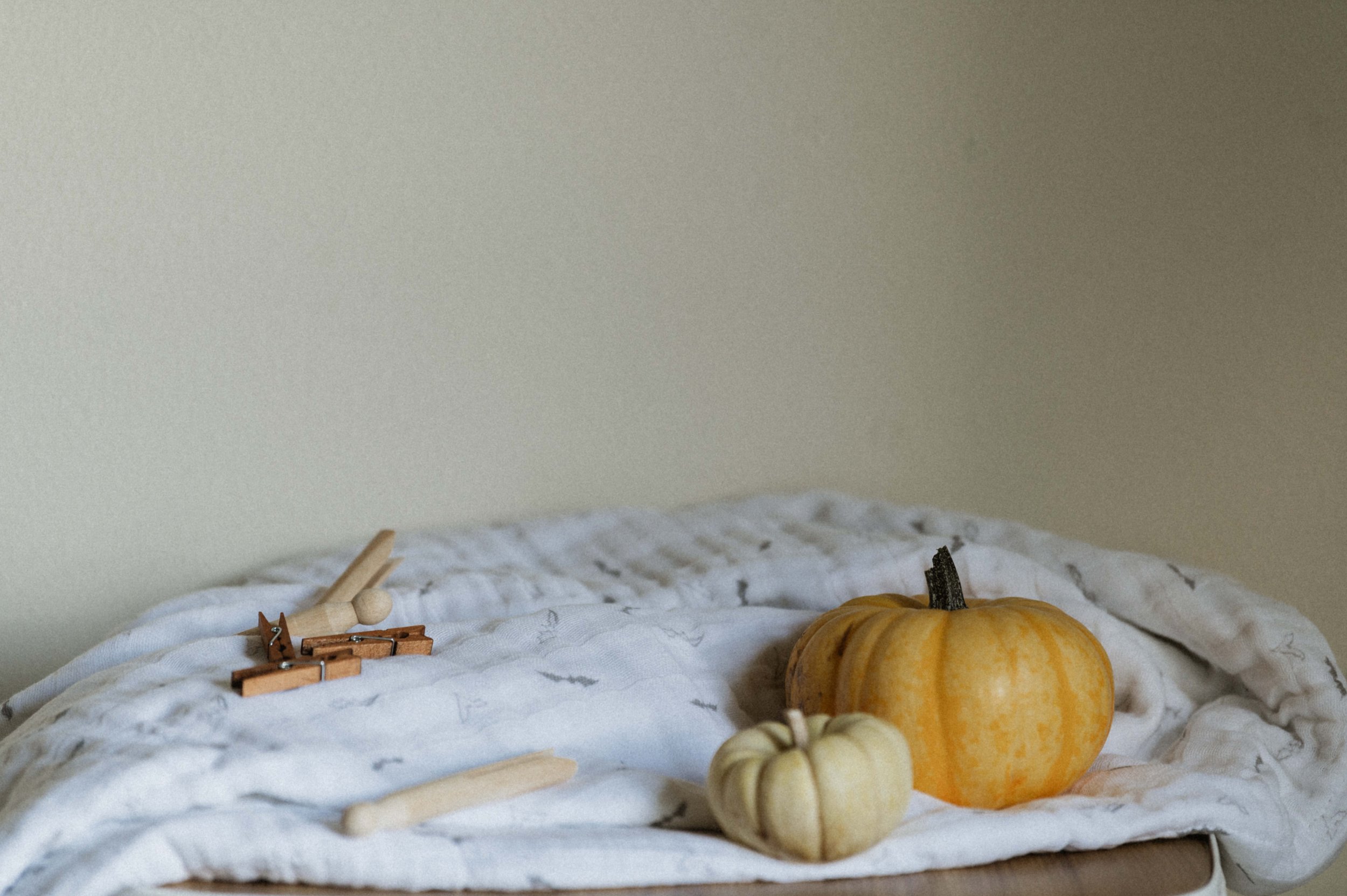 Halloween baby blanket photographer Utah styling Little Unicorn seasonal swaddle flat layProfessional product photography of organic cotton muslin Halloween print quilt
