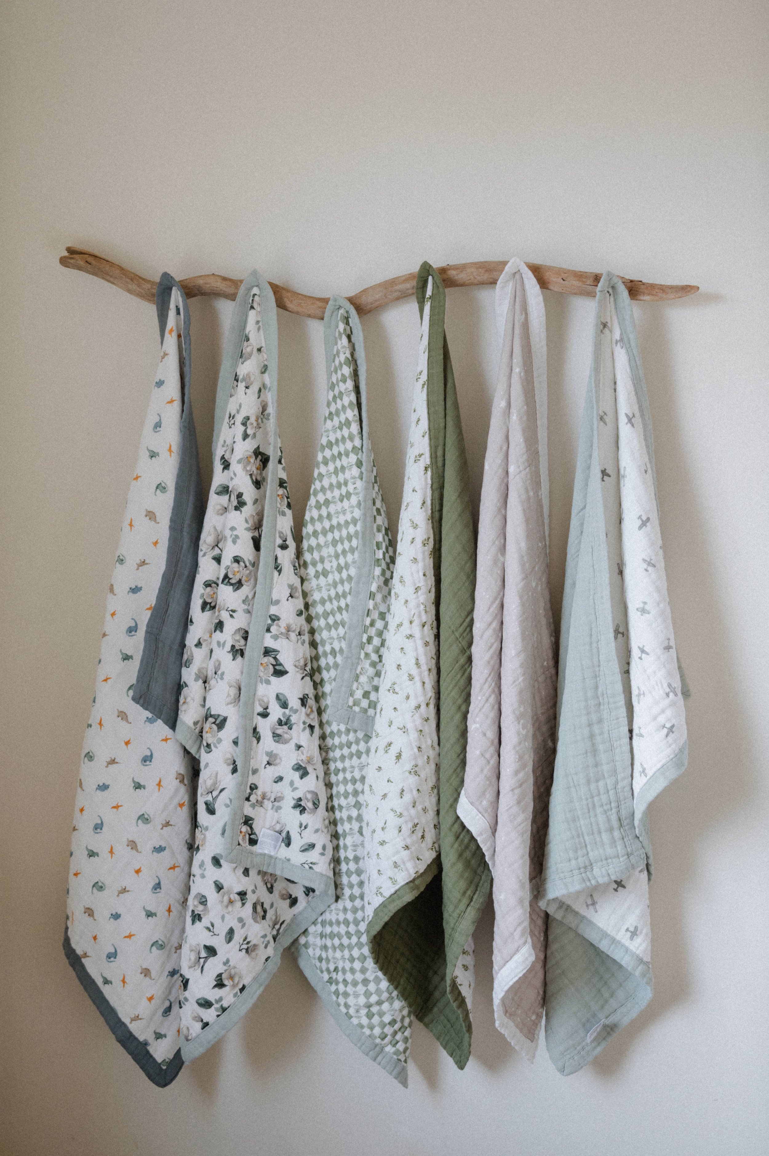 organic cotton baby blanket product photography hanging on wooden branch