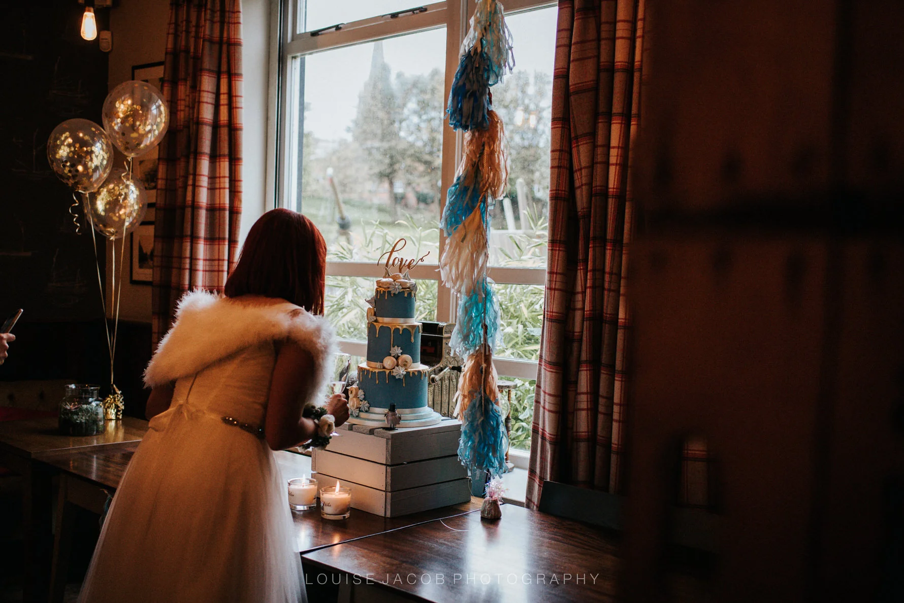 Documentary Wedding Photography bride looking at her wedding cake