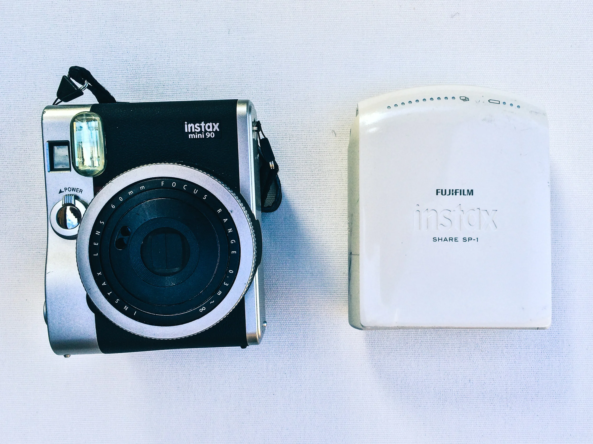 Instax share sp-1: http://www.fujifilm.com.au/products/instant_photo/printers/instax_share_sp_1 Instax mini 90: http://www.fujifilm.com.au/products/instant_photo/cameras/instax_mini_90