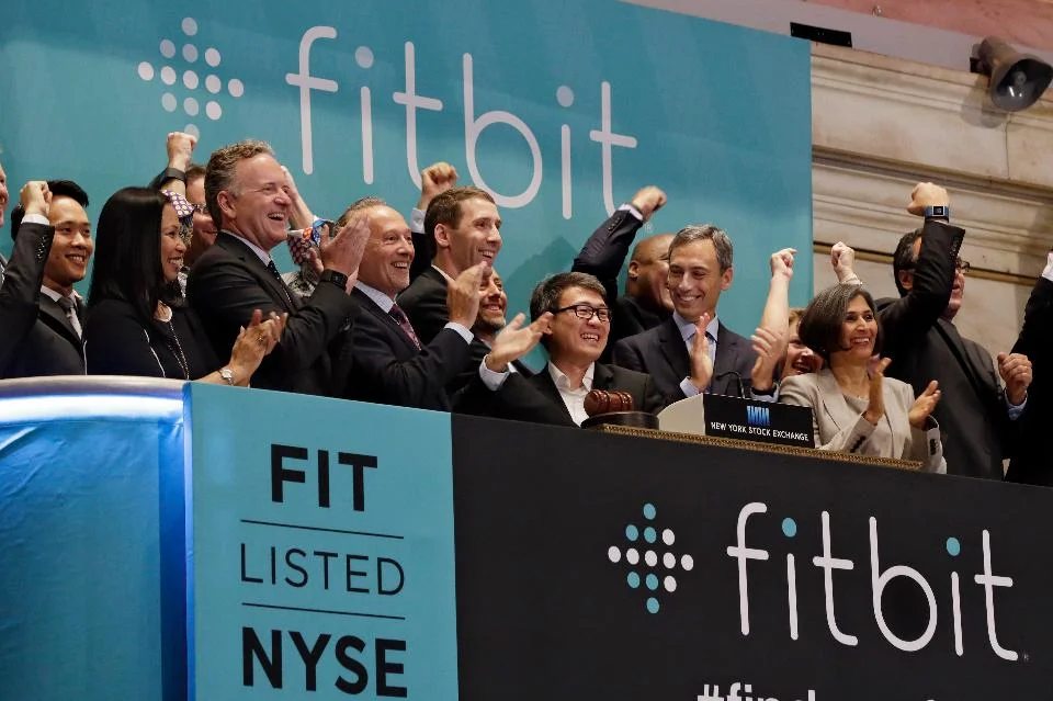 Fitbit CEO James Park, center, is applauded as he rings the New York Stock Exchange opening bell. (AP Photo/Richard Drew)