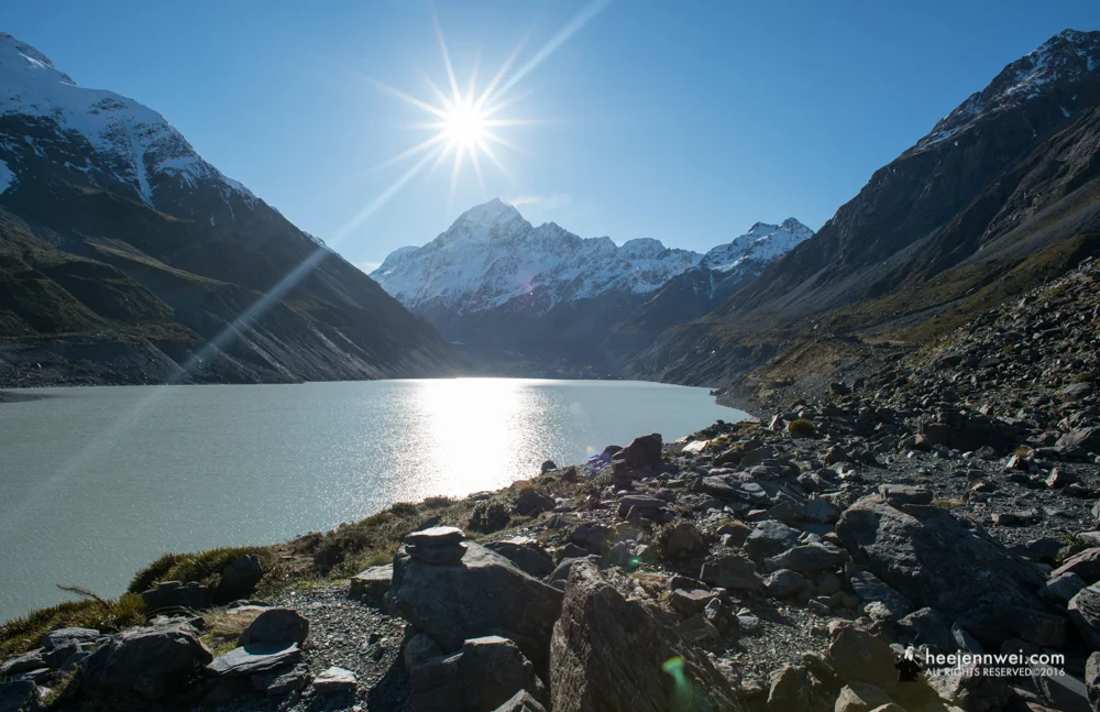 Triumph at the end of Hooker Valley Track, Hooker Lake with Aoraki Mount Cook peak. 