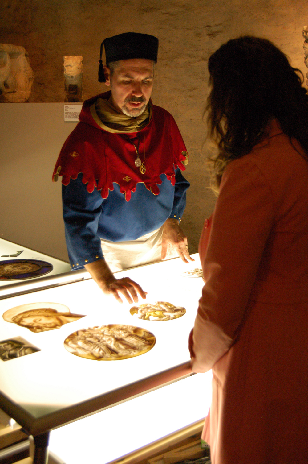 Stained glass artist J. Kenneth Leap talks with a visitor about the art of medieval stained glass painting and window making.