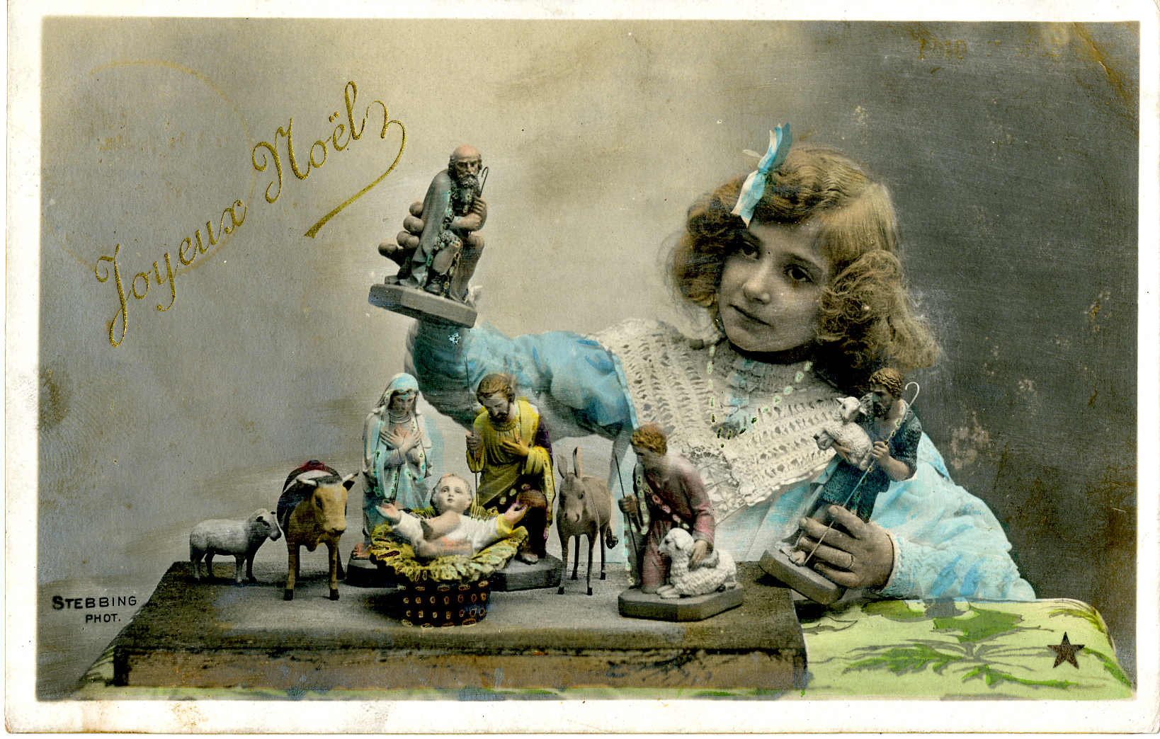 Hand tinted postcard of girl with crèche figures, circa 1910. Photographer: Professeur Stebbing, Paris, France. Publisher: Étoile, Paris. Collection of Ed Gyllenhaal.