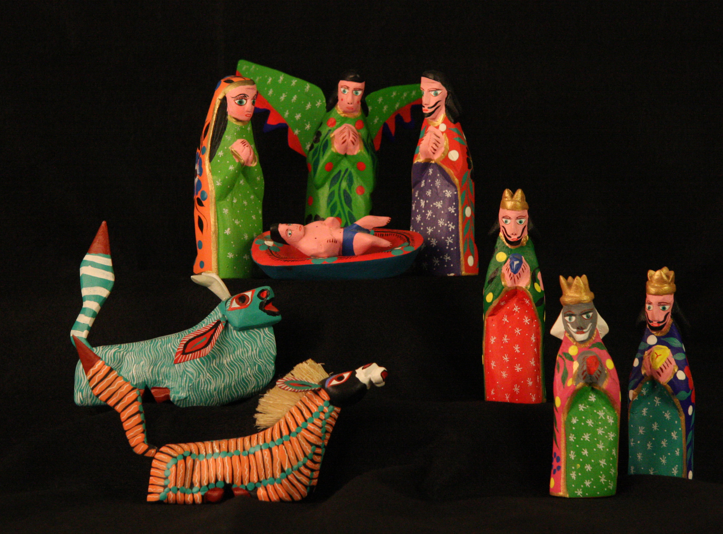 Alebrijes Nativity. San Martin Tilcajete, Oaxaca, Mexico, late 1990s. Artisans of the Oaxaca valley carve Alebrijes figures using the wood of the local copal tree. Some of the carvings depict mythical creatures with roots in pre-Christian beliefs. The animals in this Nativity set apparently represent the traditional ox and donkey, but have been carved and painted in the style of the fantastic Alebrijes creatures. Collection of Glencairn Museum, gift of Frank and Mary Herzel.