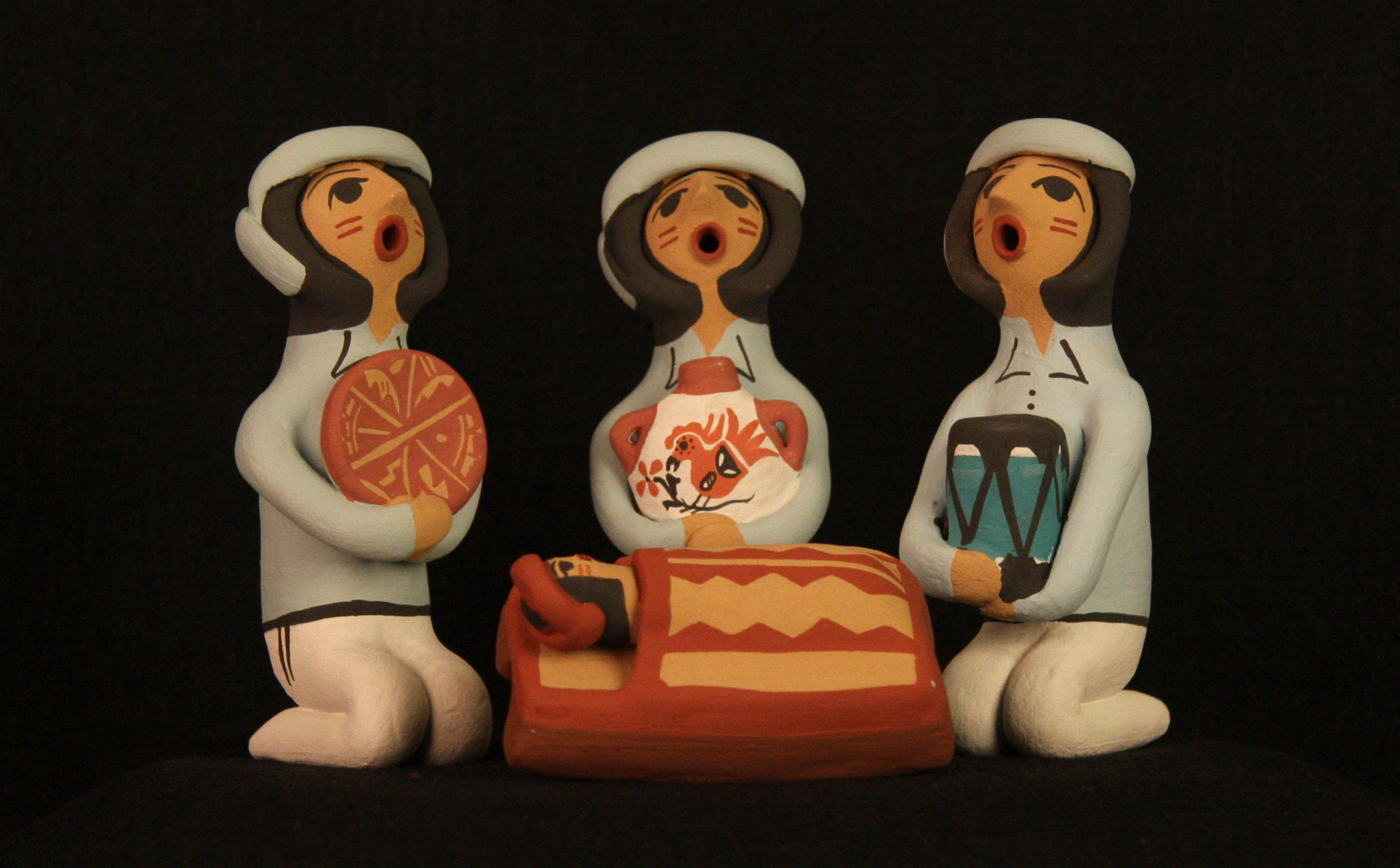 This Pueblo Indian Nativity ( nacimiento ) was made in 2011 by Cheryl Fragua of the Jemez Pueblo, New Mexico, using clay and natural pigments. Most of the residents of the Pueblos have accepted Christianity as an addition to their own pre-Christian traditions. Today a number of Pueblo Indian artisans make Nativities regularly, along with other works such as the famous ceramic storyteller figures. Indian culture is rich with myths and stories, which are used to convey traditions and values. The storyteller and Nativity figures usually have closed eyes and an open mouth in order to “let the stories out.” Collection of Glencairn Museum.