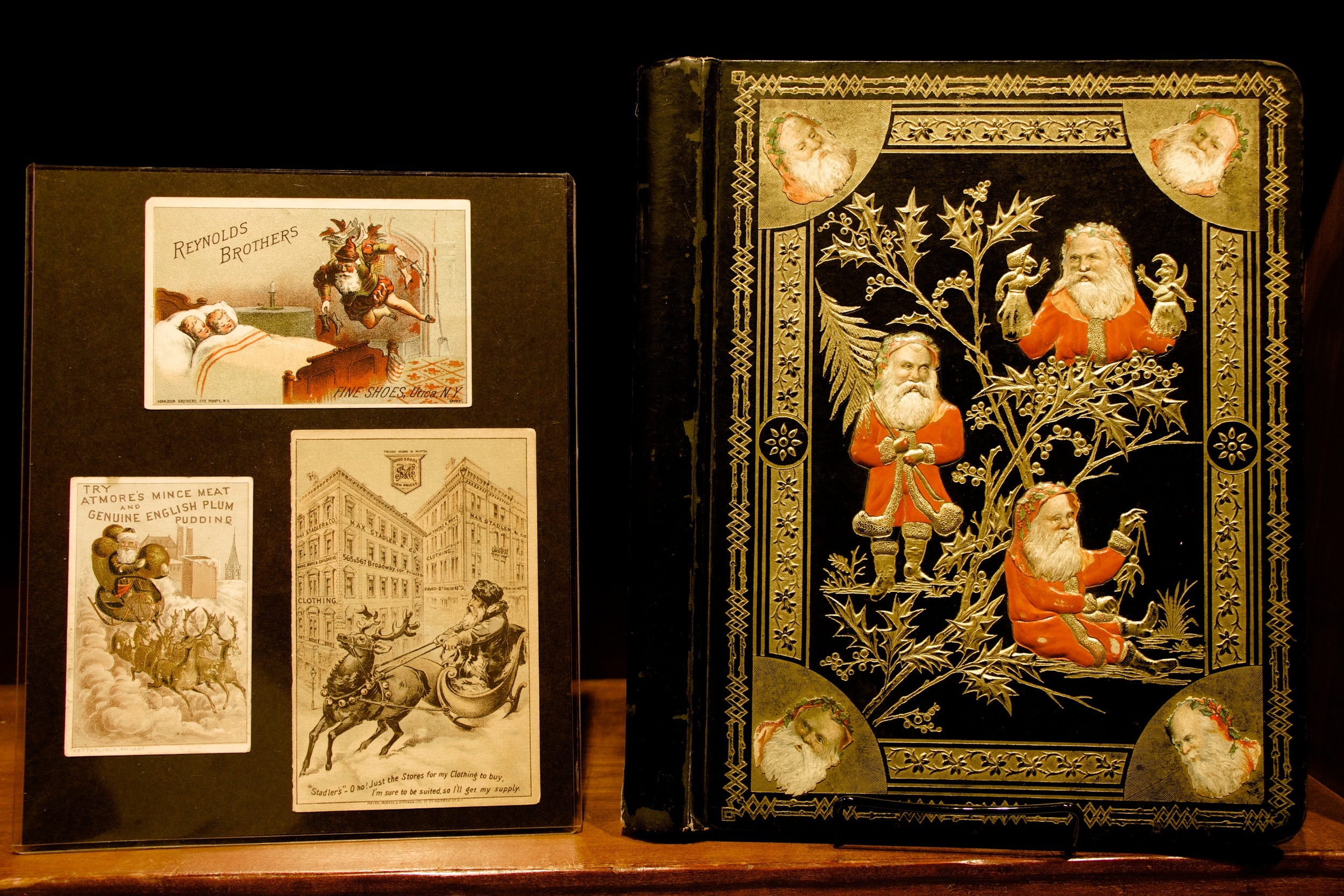 Figure 13: During the second half of the 19th century, America’s growing advertising industry adopted Santa Claus as a “spokesman” for a wide variety of products and services. Santa appeared on the covers of souvenir holiday booklets given away by stores and on colorful “trade cards” included with purchases. Trade cards were purchased by merchants in bulk, and then overprinted with the name and address of the business, or a specific product, on the front. Trade cards were given to customers throughout the year, but the Christmas-themed cards were the most popular. Many Victorian families cherished them and preserved them in special albums.