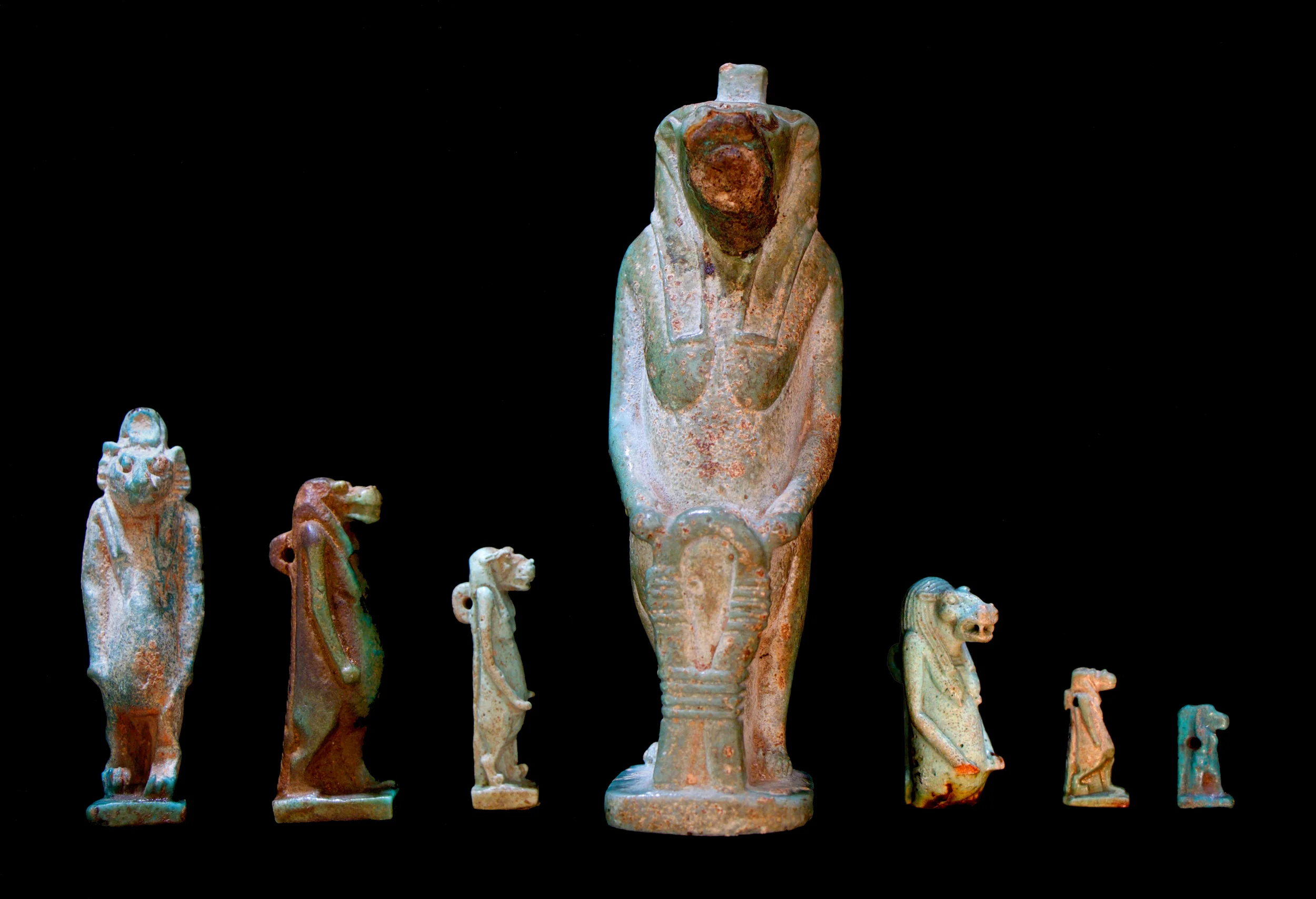 Faience statuette of Taweret (12cm) and faience amulets of Taweret (smallest = 2cm) in Glencairn Museum’s Egyptian collection.