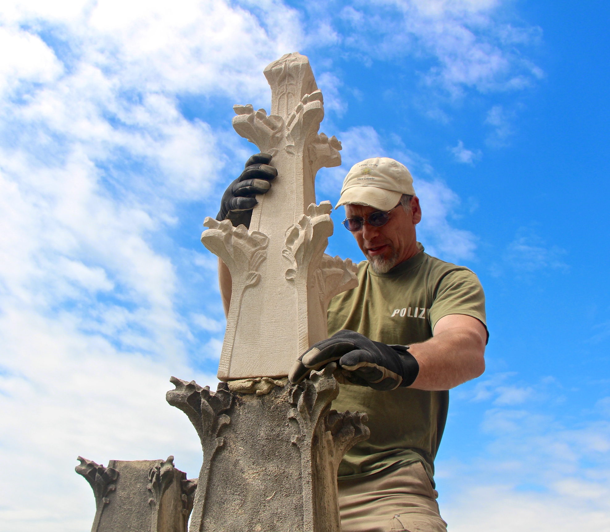 Jens Langlotz installs a new limestone finial onto an original base above the south entry to Bryn Athyn Cathedral.