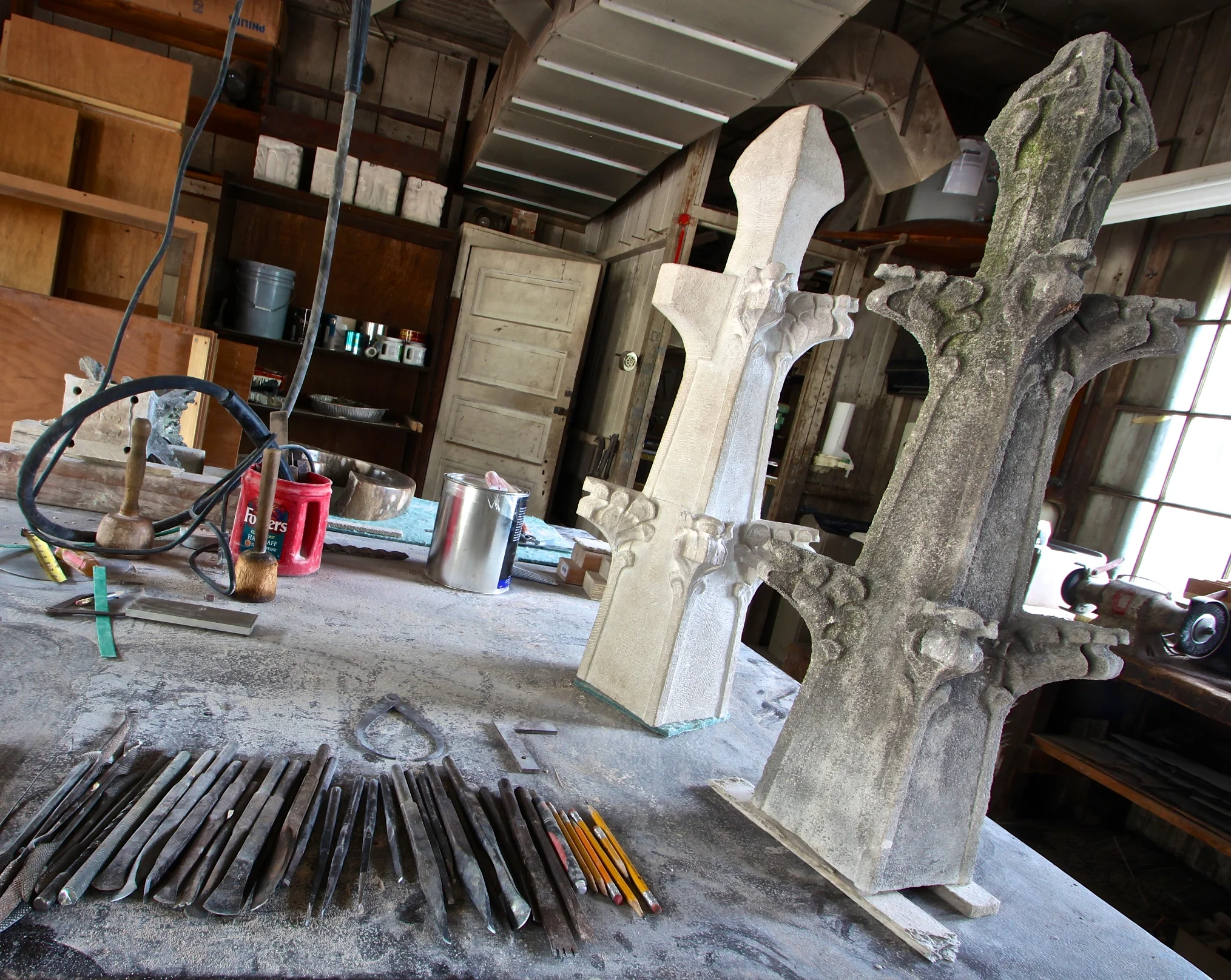 Figure 5: In the Bryn Athyn Cathedral workshops, a new limestone finial (left) is in the process of being carved. This is an exact copy of the original, degraded finial (right).
