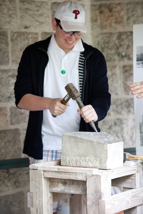 A Visitor Tries His Hand at Stone Carving