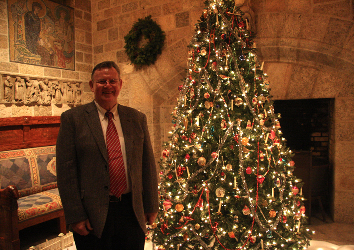 Brother Bob Reinke Poses with His Vintage Tree and Christmas Village