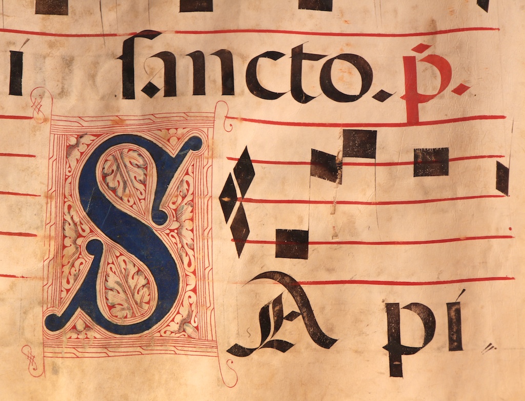 Figure 2: An example of the inkwork from folio 38v showing an illuminated letter “S” using blue and red ink as well as red and black text and music notation. Beyond the musical function, this hymnal was intended as a valued possession and a work of art folio, although the illumination style is relatively modest compared to some of the lavish presentation manuscripts that were made; see Figure 3 for one example of a contrasting style.