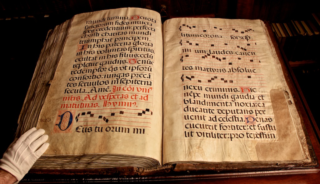 Figure 8: Most of the manuscript is dedicated to hymns where the chant is notated with the first verse, and subsequent verses are written without repeating the music. Folios 126v-127 show the last three verses of “Eterna Christi munera” as well as the first three verses of “Deus tuorum militum.” As is evident, the singers would need to have the melody memorized before turning the page to the later verses. Note also the vellum patch on the lower right corner, showing the wear and tear of a book that was in regular use.