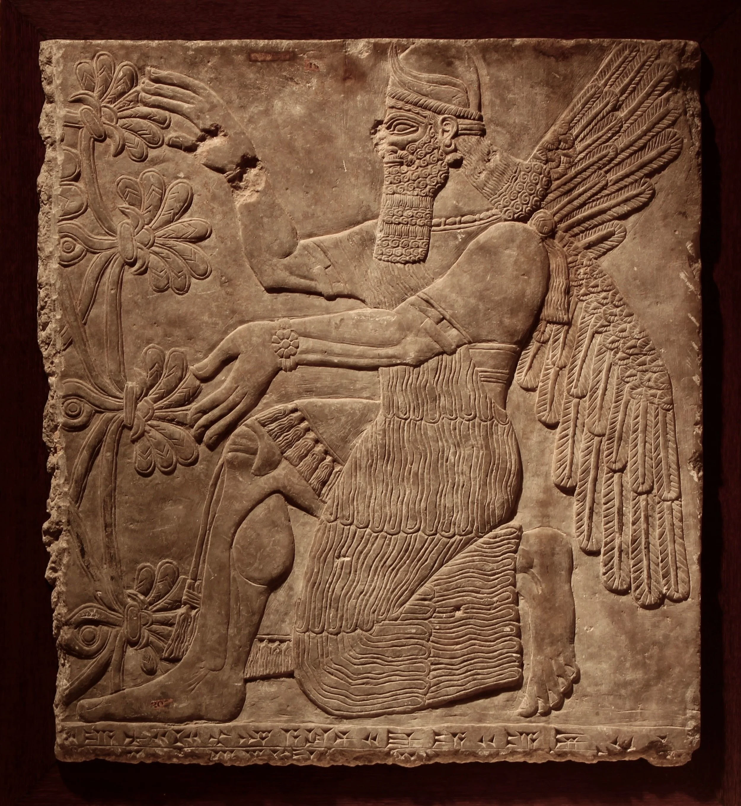 Figure 2: A kneeling genie, Northwest Palace of Ashurnasirpal II at Nimrud, Iraq. (09.SP.1549; 77 x 68.5 cm )