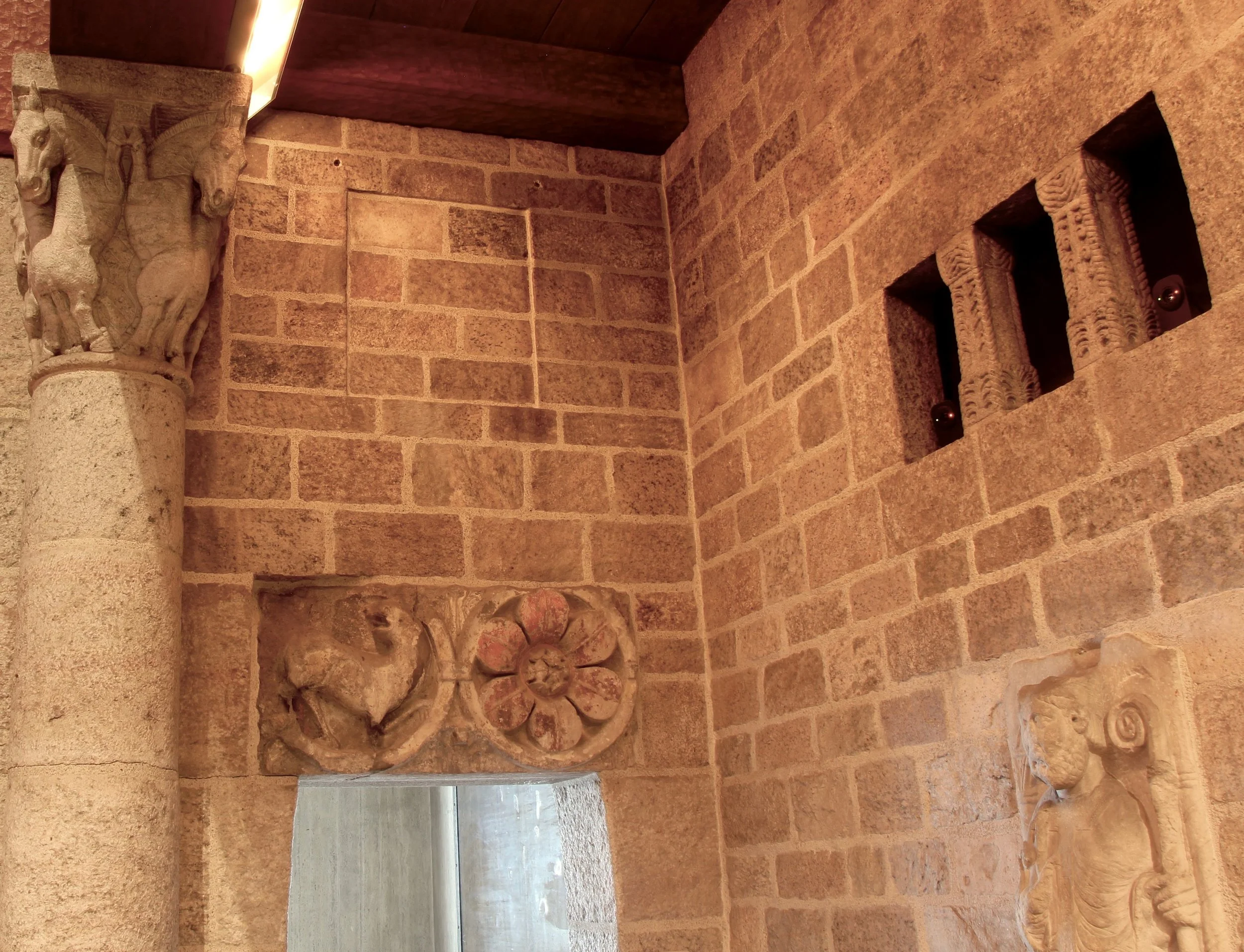 Figure 9: Raymond Pitcairn chose to exhibit one of his Assyrian reliefs in the northwest corner of the Great Hall of Glencairn: a royal eunuch attendant from the Central Palace of Tiglath-Pileser III (Figure 3). However, originally the space seems to have been prepared for the square frame of the smaller relief of the head of the genie from the Northwest Palace of Ashurnasirpal II (Figure 1). A square, recessed niche is still visible above the open doorway. At some point the relief was removed, and now all five Assyrian reliefs are on exhibit in Glencairn's Ancient Near East gallery. Pitcairn also displayed three Assyrian reliefs in his personal office in Glencairn's basement.