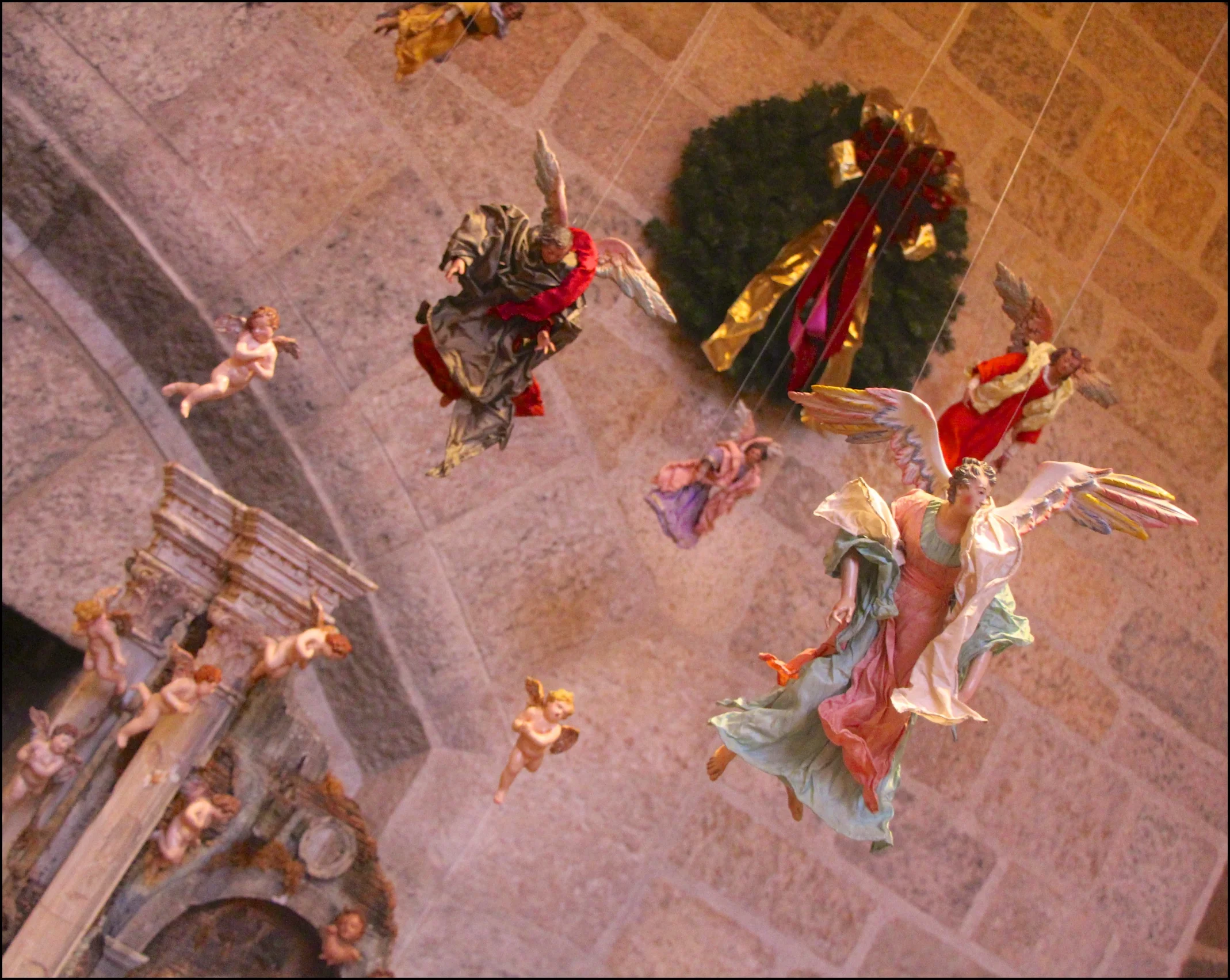 Figure 16: The angels and cherubs suspended above the Nativity scene may refer to a passage from the Nativity story in the Gospel of Luke: ”And suddenly there was with the angel a multitude of the heavenly host praising God and saying: ‘Glory to God in the highest, and on earth peace, goodwill toward men!’” (2:13-14).