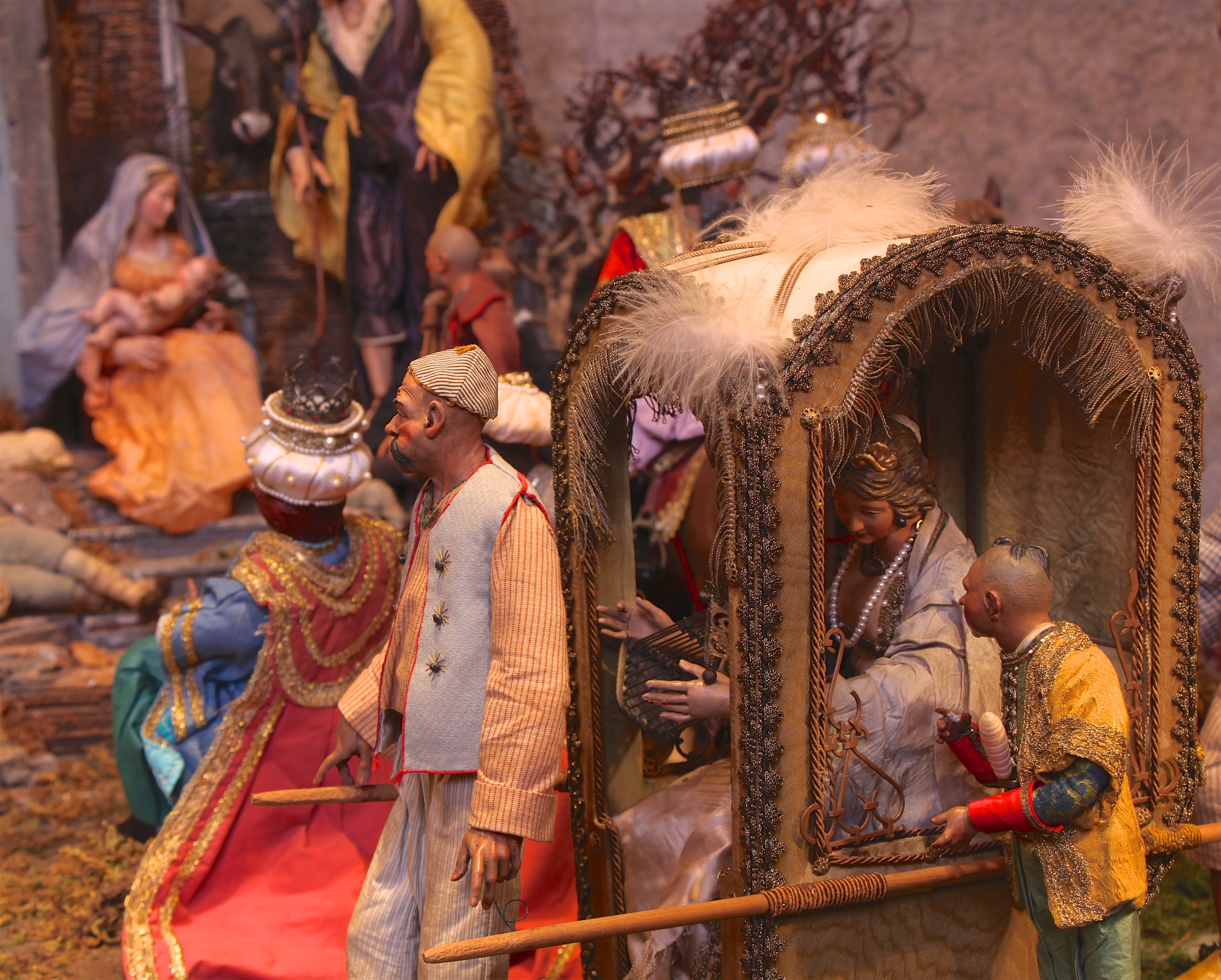 Figure 17: All segments of society, rich and poor, are present in a Neapolitan Presepio. An aristocratic lady arrives at the Nativity scene in a sedan chair, carried by attendants.