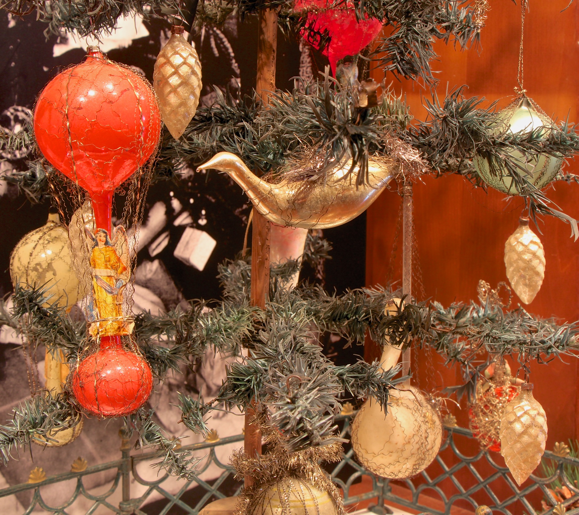 Figure 13: Molded glass Christmas tree ornaments were invented in 1870 in the small German town of Lauscha, when a glassblower blew a bubble of glass into a pinecone-shaped cookie mold. Lauschan families produced Christmas ornaments as a cottage industry in home workshops; men did the glassblowing, women did the silvering, and children helped with the decorating. In 1880 F.W. Woolworth placed an order for these ornaments from an importing firm in Philadelphia. Sales were so strong over the next few years that in 1890 Woolworth traveled to Lauscha personally and placed an order for more than 200,000 ornaments. Ornaments on loan from the National Christmas Center and Museum, Lancaster, PA.