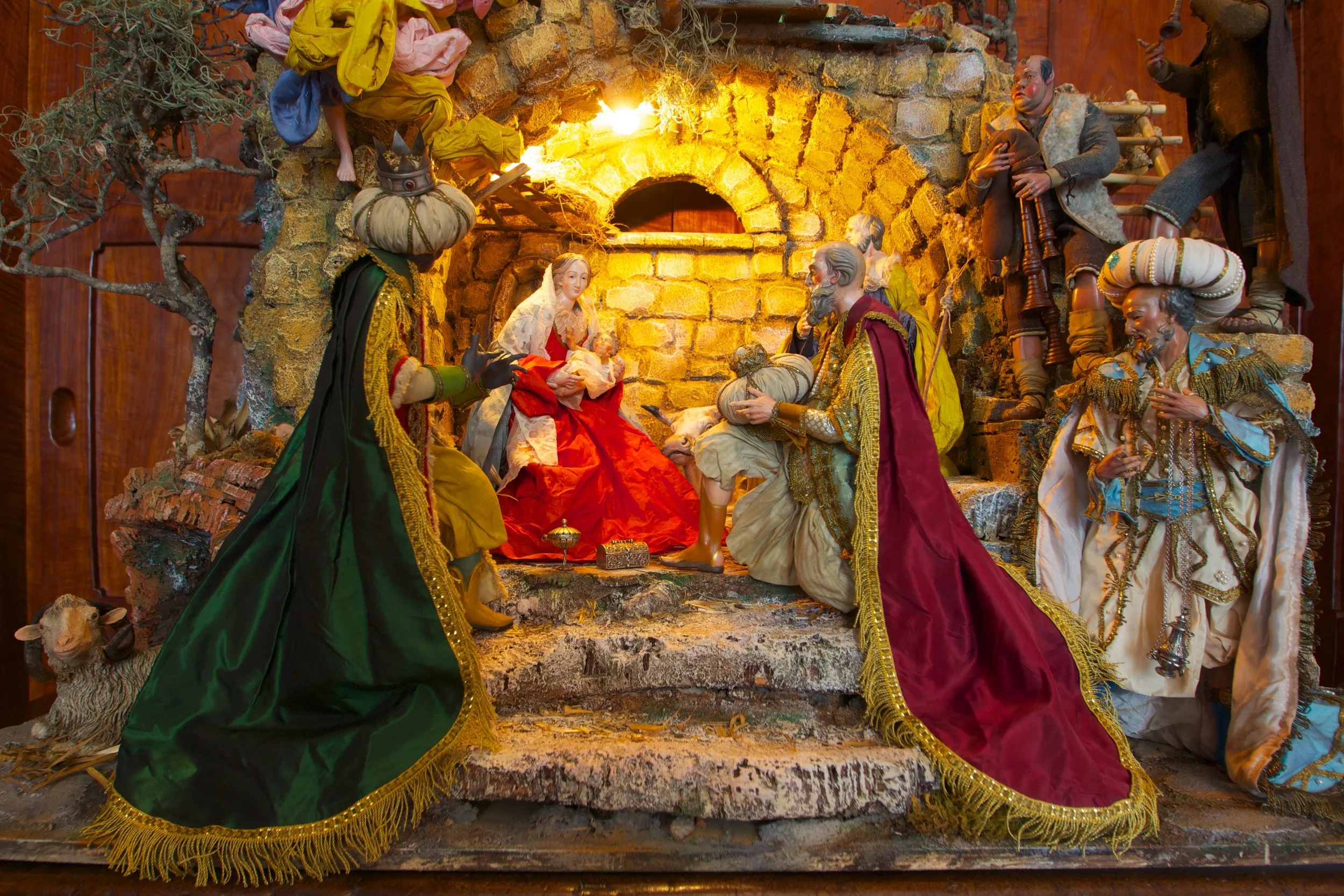 Figure 2: This Neapolitan Presepio (Nativity) is the work of the Giuseppe and Marco Ferrigno company, a fourth-generation family business located in Naples, Italy. The art has been passed from father to son since 1836, and today the Ferrignos use traditional methods and materials to make Presepio figures and scenes in the 18th-century Neapolitan style. Most of the elements in this Presepio are traditional, including the Roman ruin to symbolize the end of the pagan world, the arrival of the three Magi with gold, frankincense and myrrh, and shepherd musicians ( zampognari ). Collection of Glencairn Museum.
