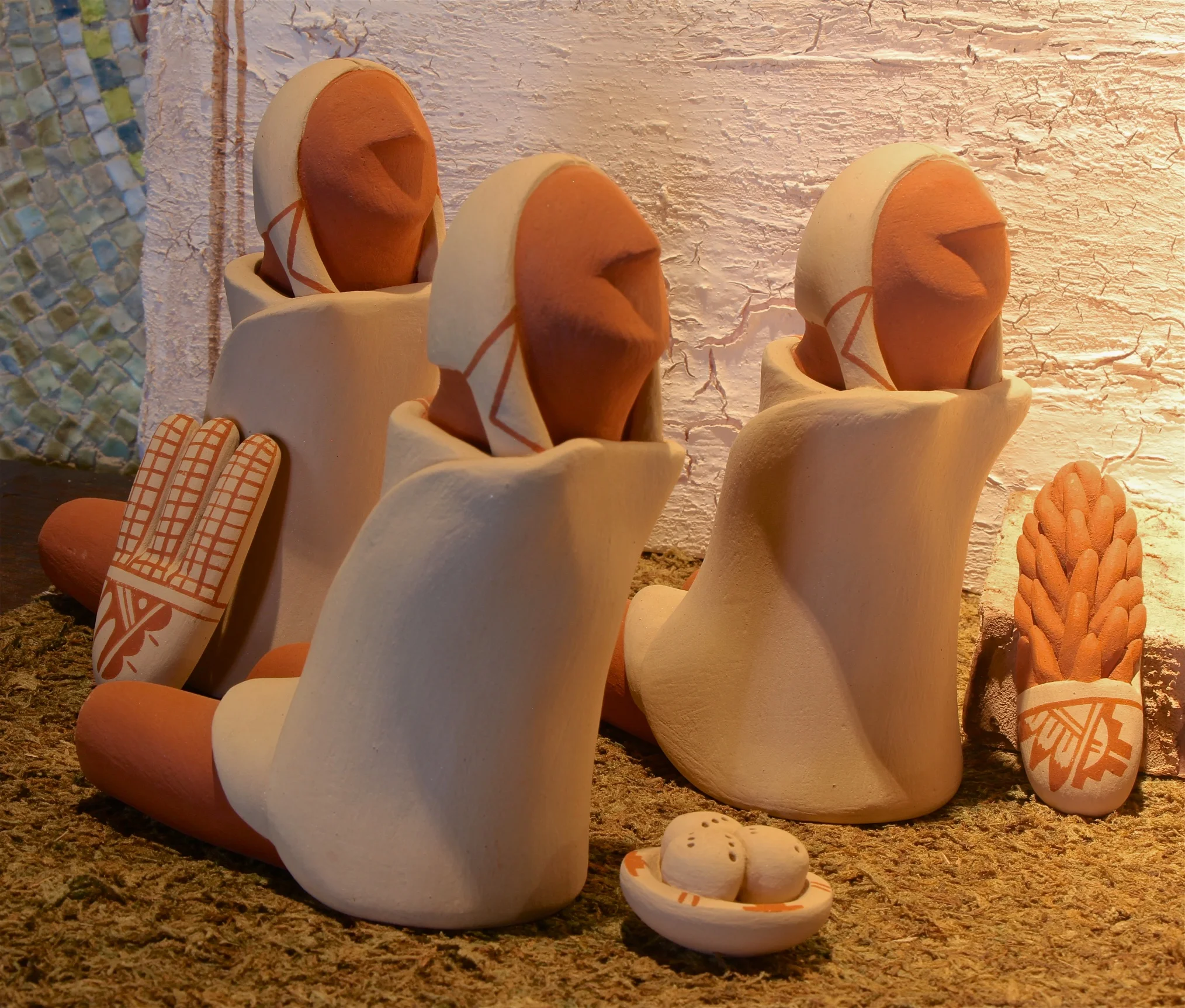 Figure 3: This nacimiento was made by Alma Concha (1941 – ) of the Jemez Pueblo, New Mexico, from red and buff clay in the late 1970s or early 1980s. The Magi are holding gifts appropriate to Pueblo culture: bread, corn, and chili peppers. Collection of Glencairn Museum.