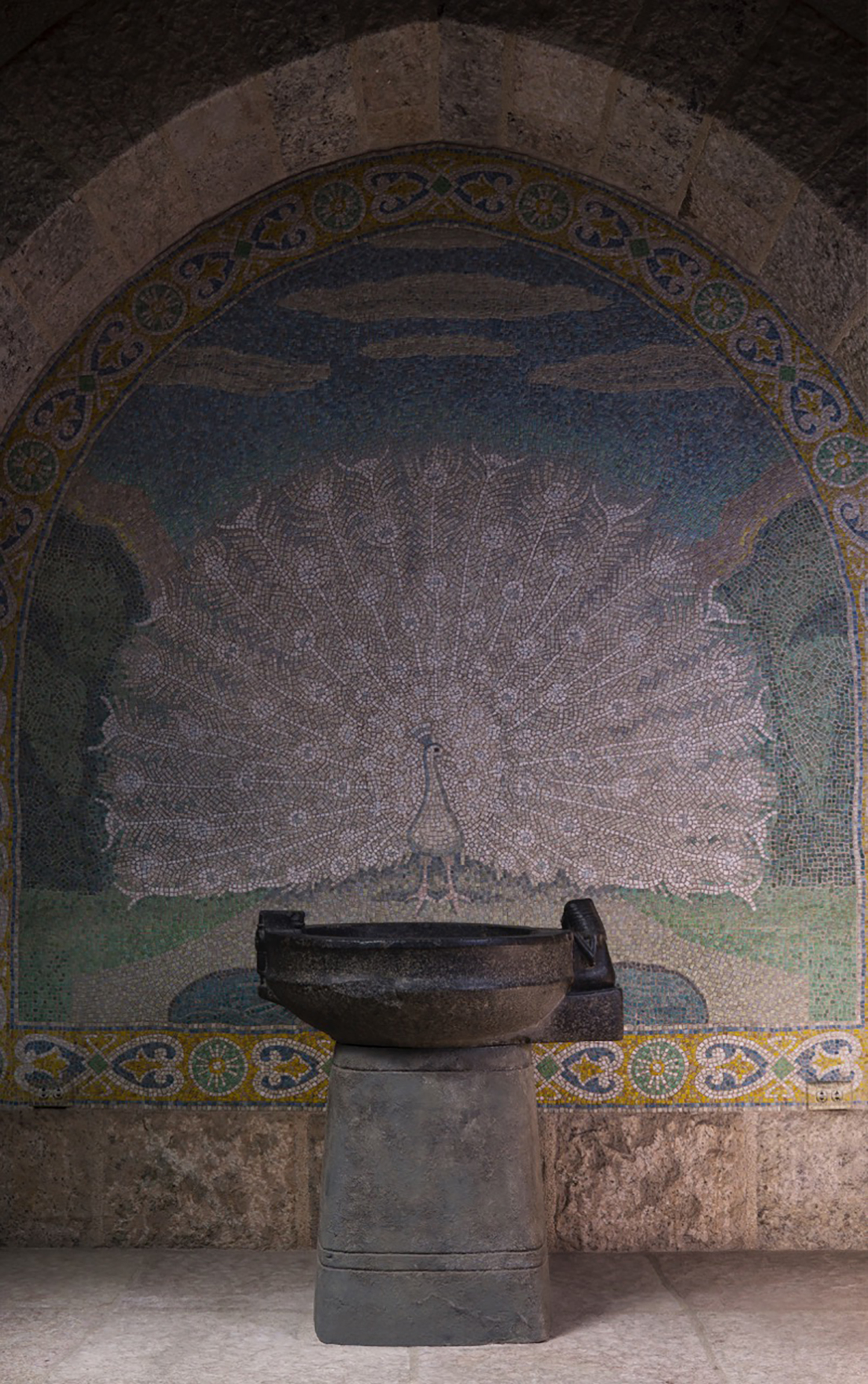 Figure 2: The niche in the “Bird Room” with a beautiful cut-glass mosaic of a white peacock. The offering basin of Lady Ruiu stands before the mosaic.