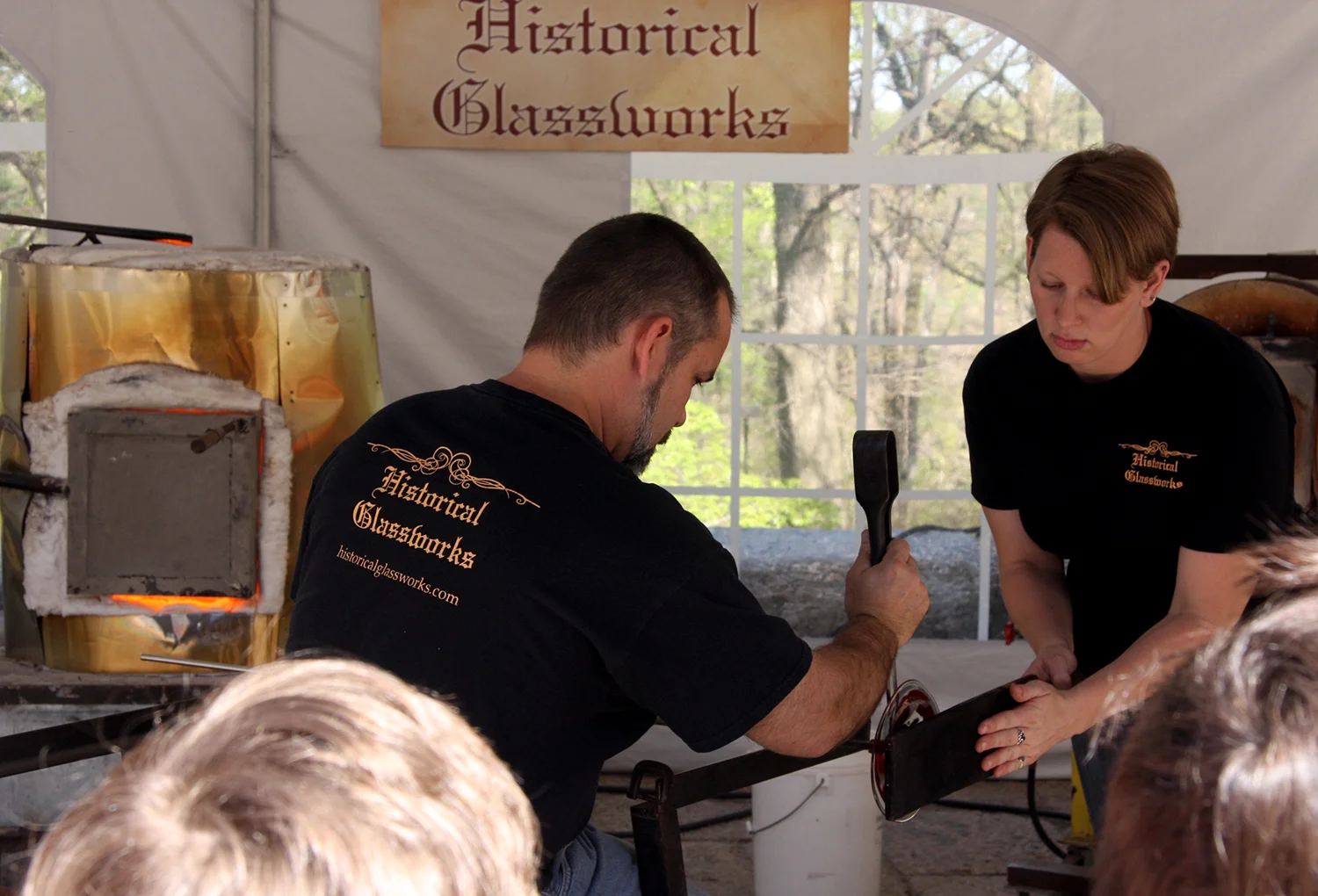 Figure 2: Jason Klein uses the jacks, a pair of flexible clamps made from spring steel, while his assistant holds a piece of wet wood to mold or guide the rondel they are creating.