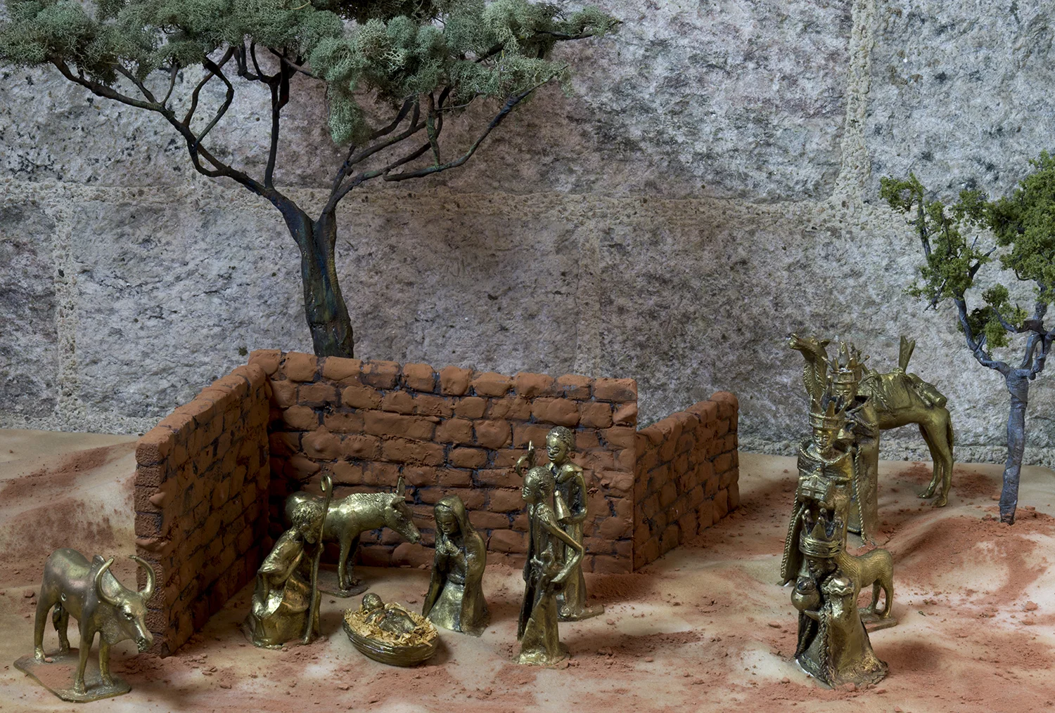 Figure 9: This Nativity was made by artisans in Burkina Faso, West Africa, using the ancient technique of lost wax casting. Each figure is first modeled in beeswax, then covered with a layer of clay, with a hole left at the top of the clay layer. The clay is then left to harden in the sun, after which the piece is held briefly in a fire so that the beeswax inside the clay melts. The bronze is prepared by melting scrap metal over a fire, and once it has become liquid it is poured into the clay mold. When the metal has hardened the outer clay layer is broken and removed. The bronze pieces are then rubbed with sand to give them a smooth finish. On loan from the National Christmas Center & Museum, Lancaster County, Pennsylvania.