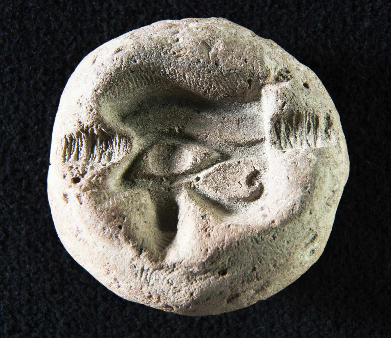 Figure 5: Faience amulets were often mass-produced in ceramic molds, such as this example in Glencairn Museum (E522) depicting a wedjat eye.