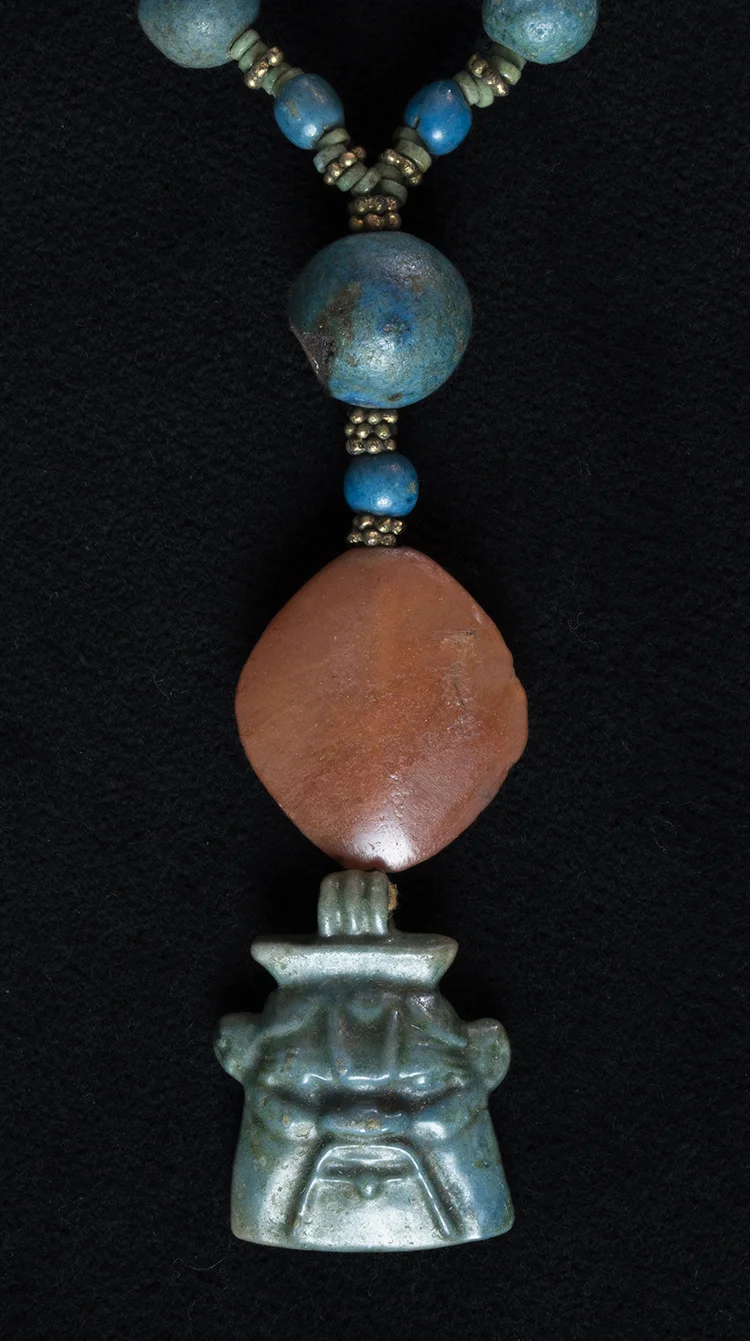 Figure 9: Bes . The Glencairn collection has Bes amulets which depict Bes fully (Figure 8 above, 15.JW.17) and others which take the form of only his head (15.JW.241), highlighting his grimacing visage.