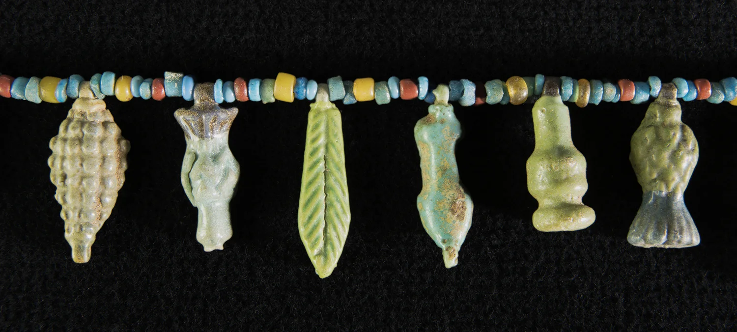 Figure 23: Floral Elements . Many of the Glencairn necklaces feature floral elements. Most are made of faience and may have originally come from elaborate broad collars with a floral design. These faience collars imitate actual floral collars, which may have been worn on festive occasions during life and were certainly used as decoration in funeral settings (see Figure 24). Glencairn Museum 15.JW.515.