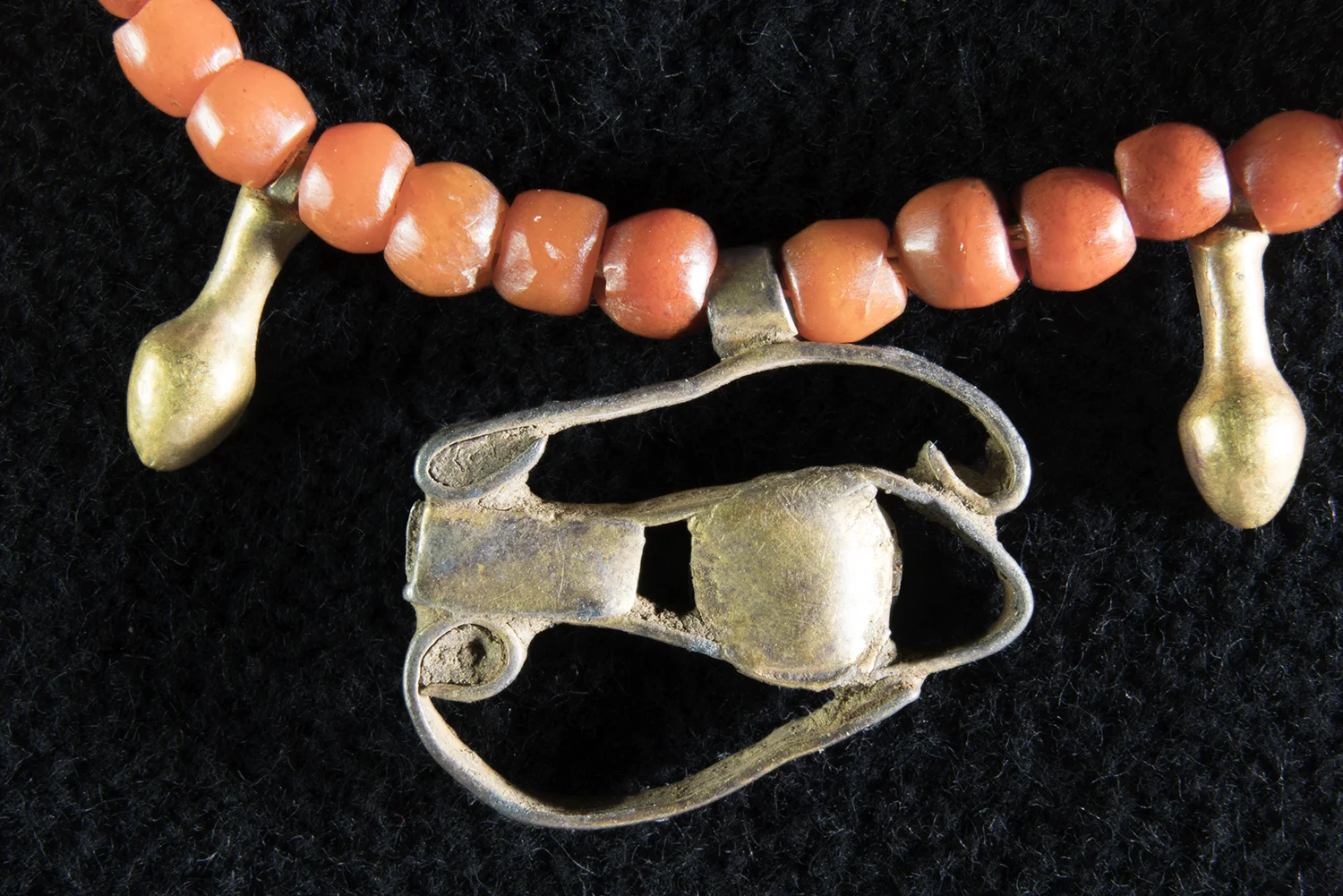 Figure 34: Wedjat Eye . There are quite a few examples of wedjat eye amulets and rings in the Glencairn collection, made of a variety of materials, several turquoise-colored faience amulets (see Figure 33), and this example, made of strips of gold. Glencairn Museum 15.JW.191.