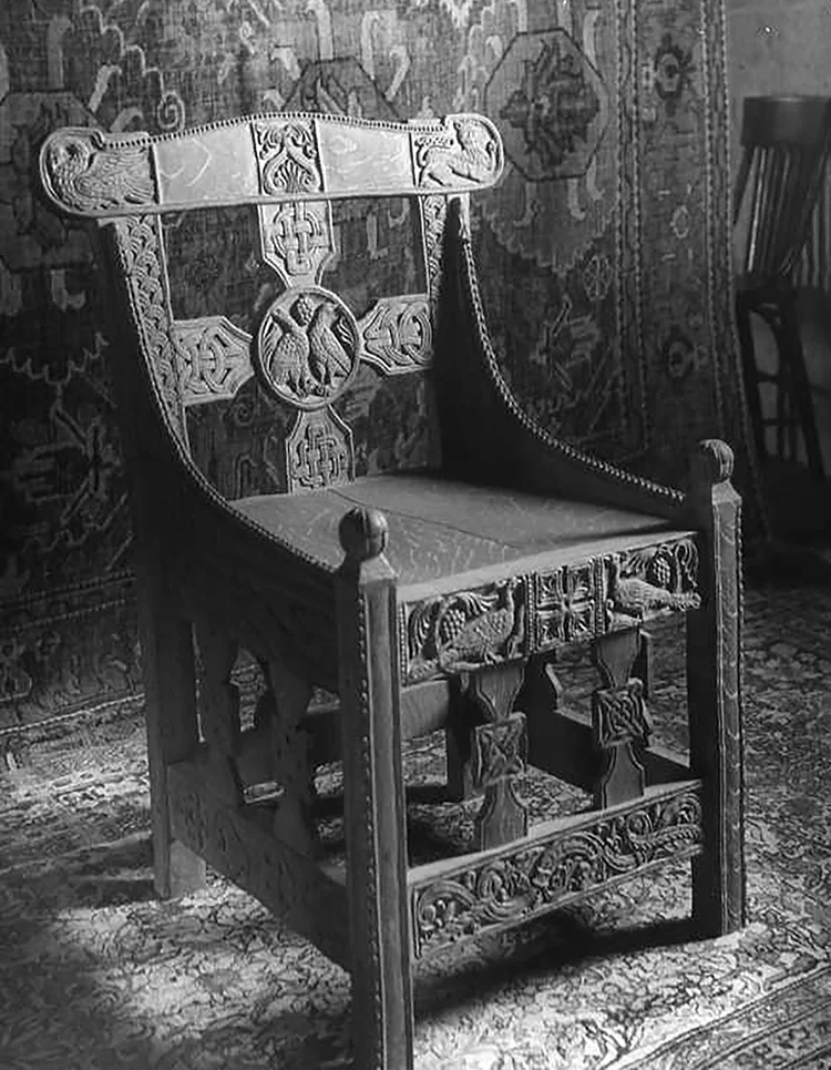 Figure 20: At some point after it was carved, Glencairn's "Tyldal chair" was photographed in the Bryn Athyn Cathedral woodworking shop with an oriental rug as a backdrop. Several of the Cathedral's chairs were photographed as well. This archival photograph (#3875) comes from a collection of glass negatives in the Glencairn Museum Archives.