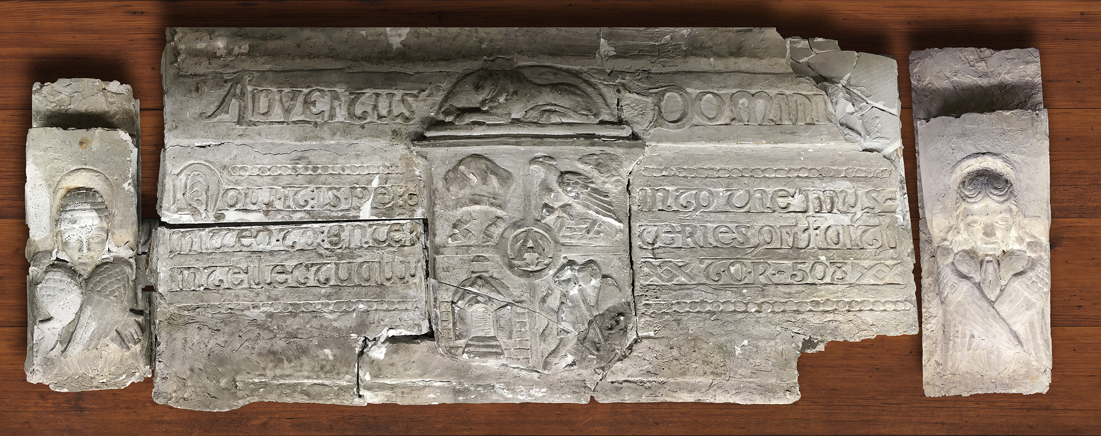 Figure 15: A plaster model for the lintel above Glencairn's chapel door depicting the seal for the Academy of the New Church, a pair of angels, and a quotation from Emanuel Swedenborg. It was probably cut from the larger plaster model used at the wedding reception in 1934. It has been preserved in Glencairn's collection of architectural models.