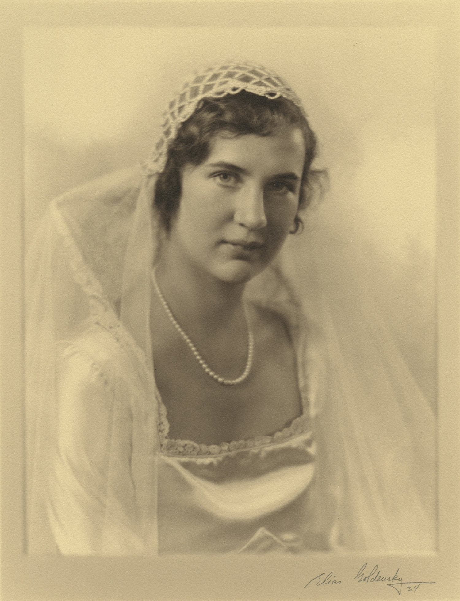 Figure 2: Gabriele Pitcairn posing for one of her formal wedding portraits. "The bride was attired in a white satin gown with lace stand-up collar and train, and wore a cap of rhinestone crossed bands" (“Church News,” New Church Life 1934, p. 296). Photograph by Elias Goldensky.