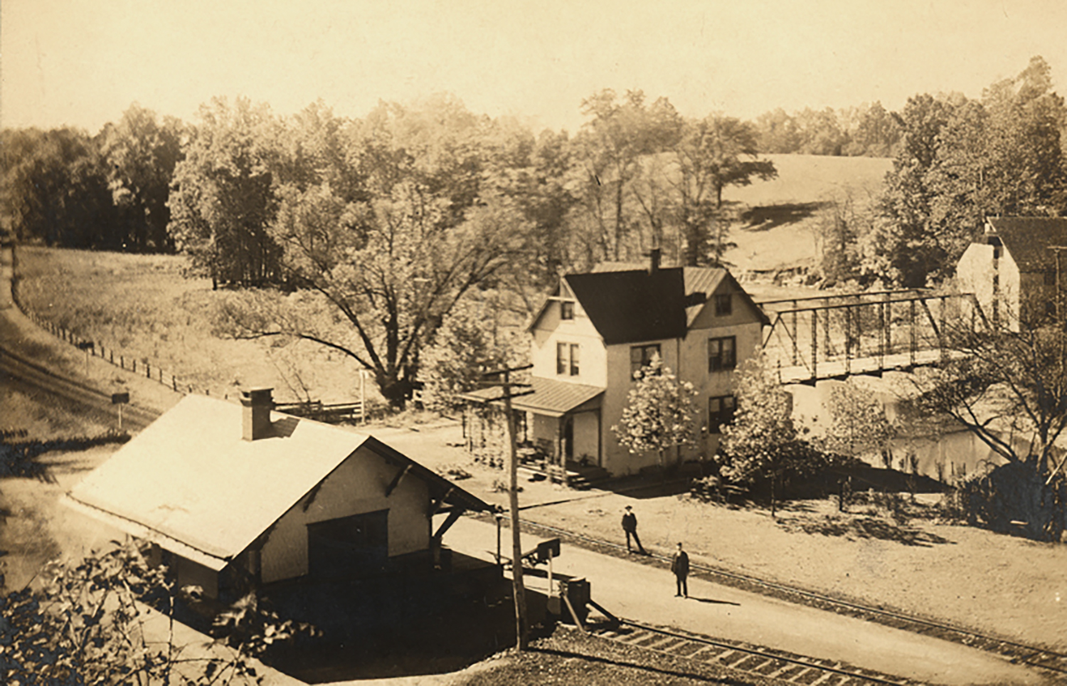 Figure 5: This photograph (circa 1902) shows both the old Alnwick Grove train station (right) and the new Bryn Athyn station (left). A small portion of Alnwick Grove park can be seen in this photo (upper left). Photo: Academy of the New Church Archives.