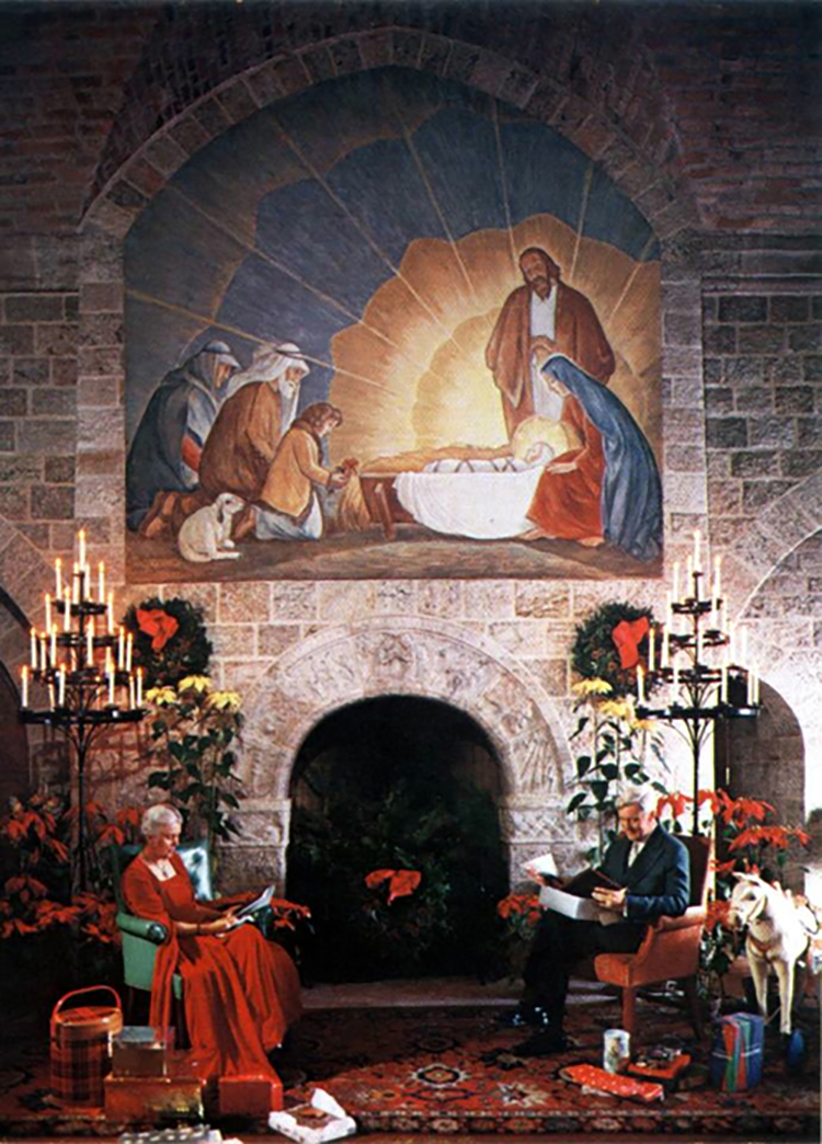 Figure 6: Raymond and Mildred Pitcairn posing for their Christmas card in 1954. On the wall behind them is a Nativity painting adapted from Maud and Miska Petersham’s book, The Christ Child . The painting and fireplace arch have been reproduced within the setting of The Glencairn Nativity.