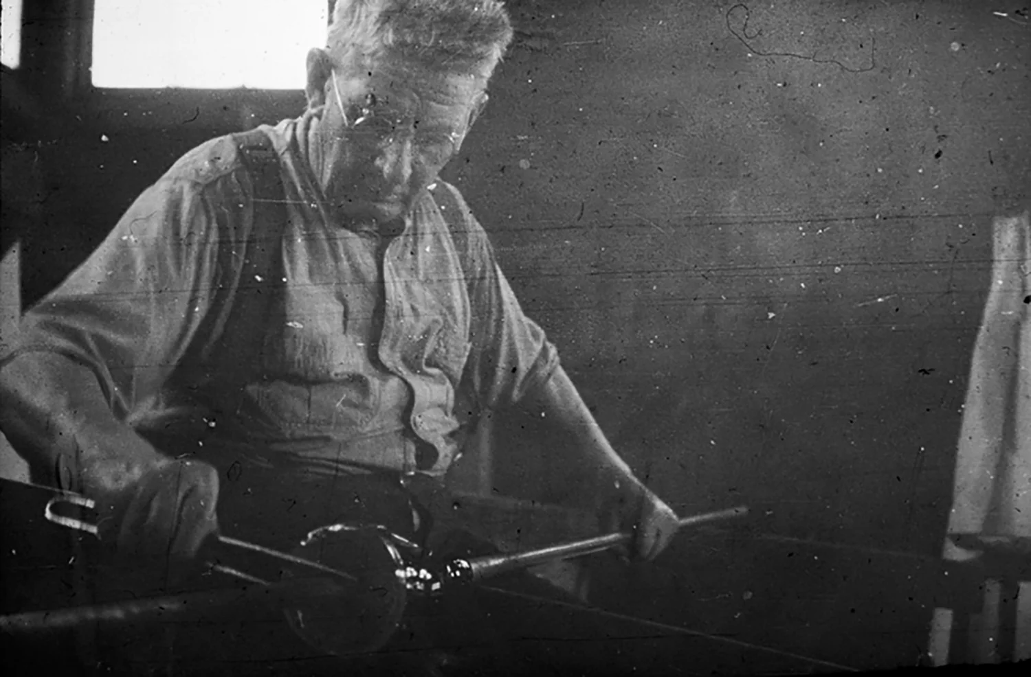 Figure 11: David Smith works at the glassblower’s bench. He emigrated from Sweden to the United States as a young man and, after working for a time as a glassblower in New York, came to Bryn Athyn in July, 1922. Smith stayed on at the factory until it closed 20 years later. He was 78 years old when he blew his last batch of Bryn Athyn glass on April 10, 1942.