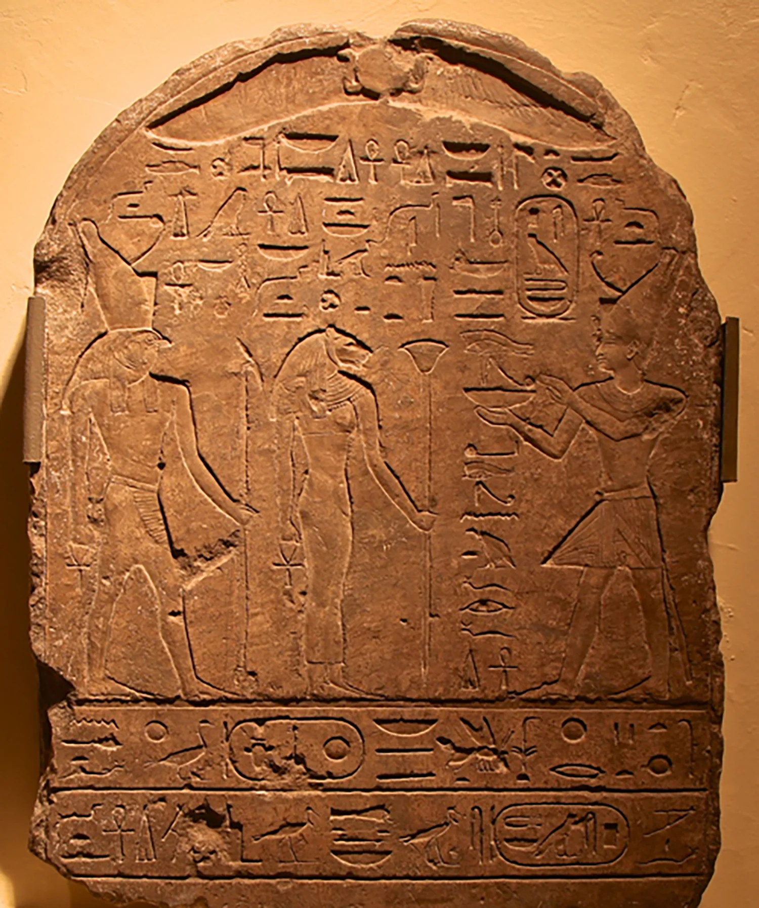 Figure 9: A stela dated to the reign of King Psammetichus II showing the king offering before Bastet and her son. Glencairn Museum E1152.