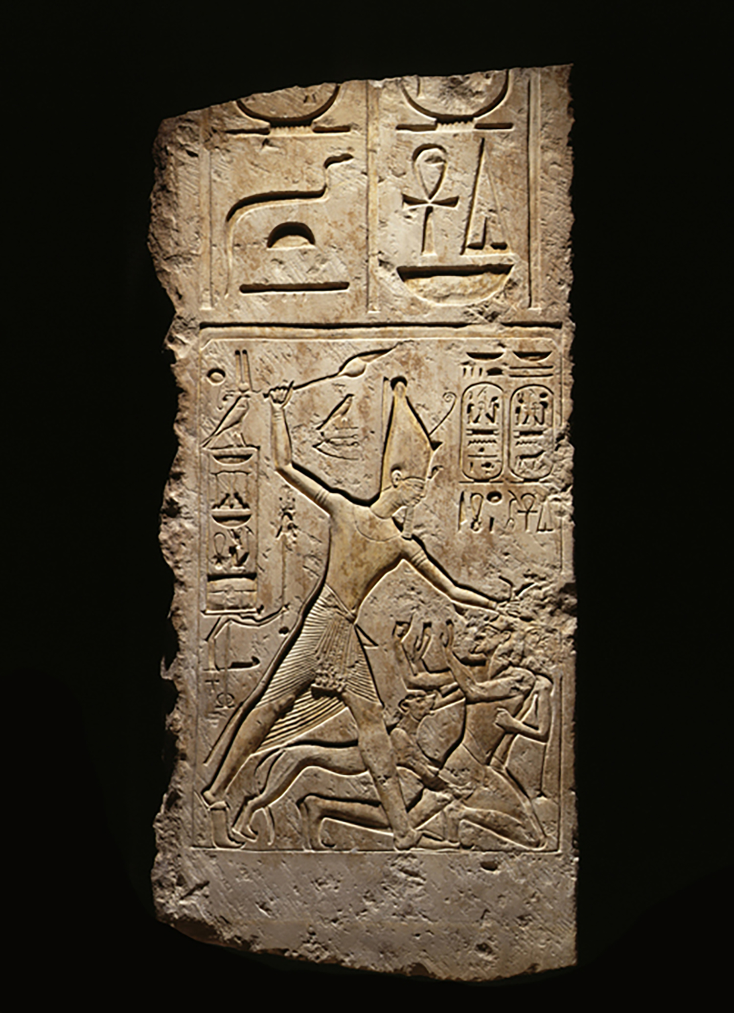 Figure 22: Limestone relief depicting Merneptah attacking enemies accompanied by a lioness, from the palace of Merenptah at Memphis, Dynasty 19 (1213-1204 BCE). Penn Museum E17527.